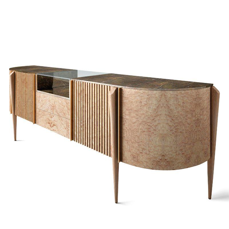 This spectacular sideboard, also available in mahogany and Calacatta marble, is deftly handmade of precious Tamo wood and Terra di Siena marble. Enriched with brass details, it features a clean yet lavish silhouette with drawers and compartments.
