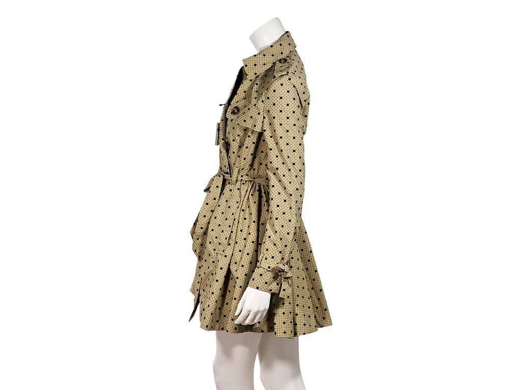 Product details:  Tan and black polka-dot trench coat by Red Valentino.  Spread collar.  Button shoulder epaulette.  Double-breasted button-front closure.  Self-tie belted waist.  Slide waist pockets.  Back storm vent.  Flared hem.  36
