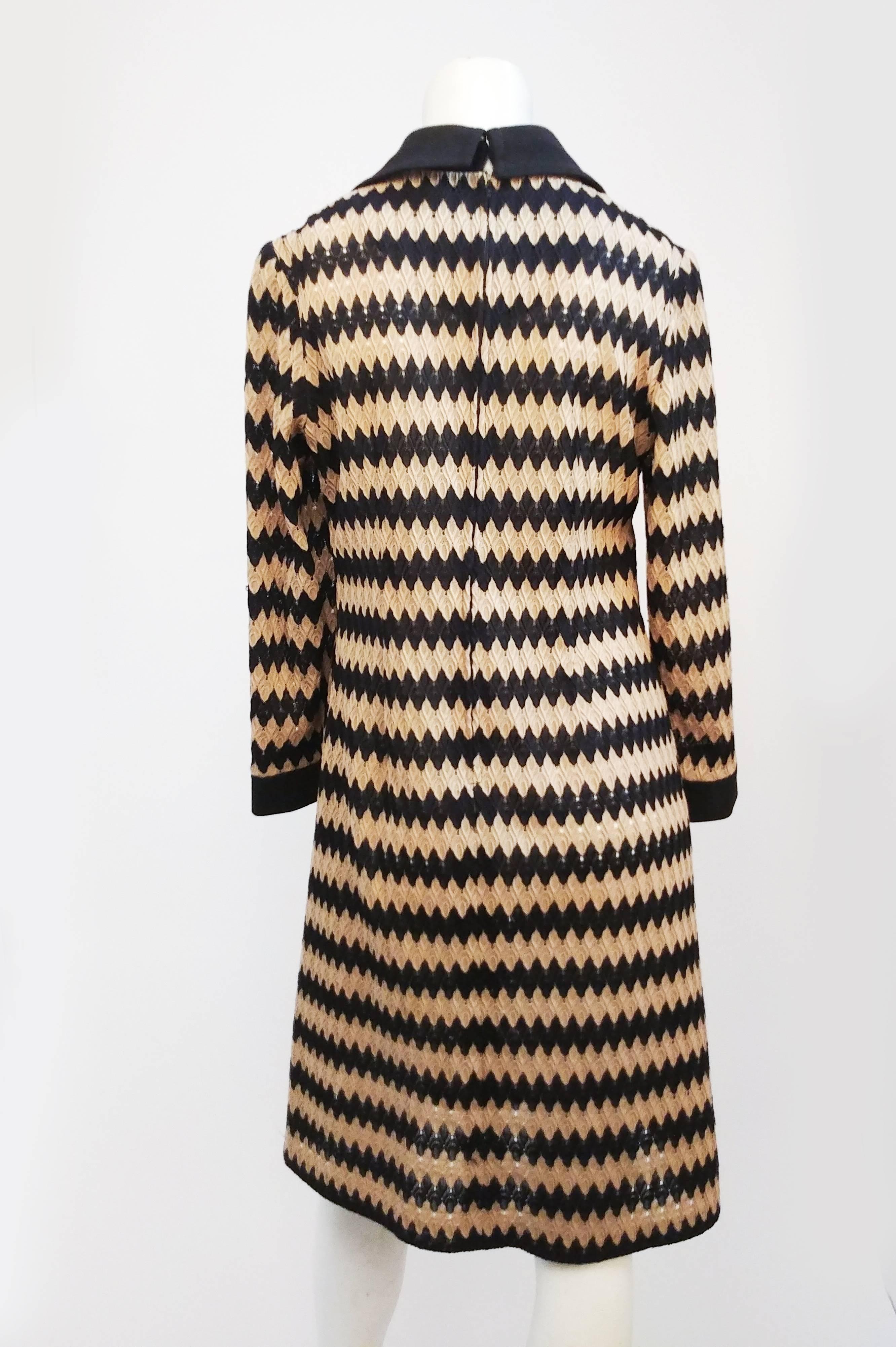 Tan and Black Knit Zig-Zag Collared Dress, 1970s. Long sleeve knit dress with contrast zigzag pattern, large 1970s collar, and matching cuffs at wrists.