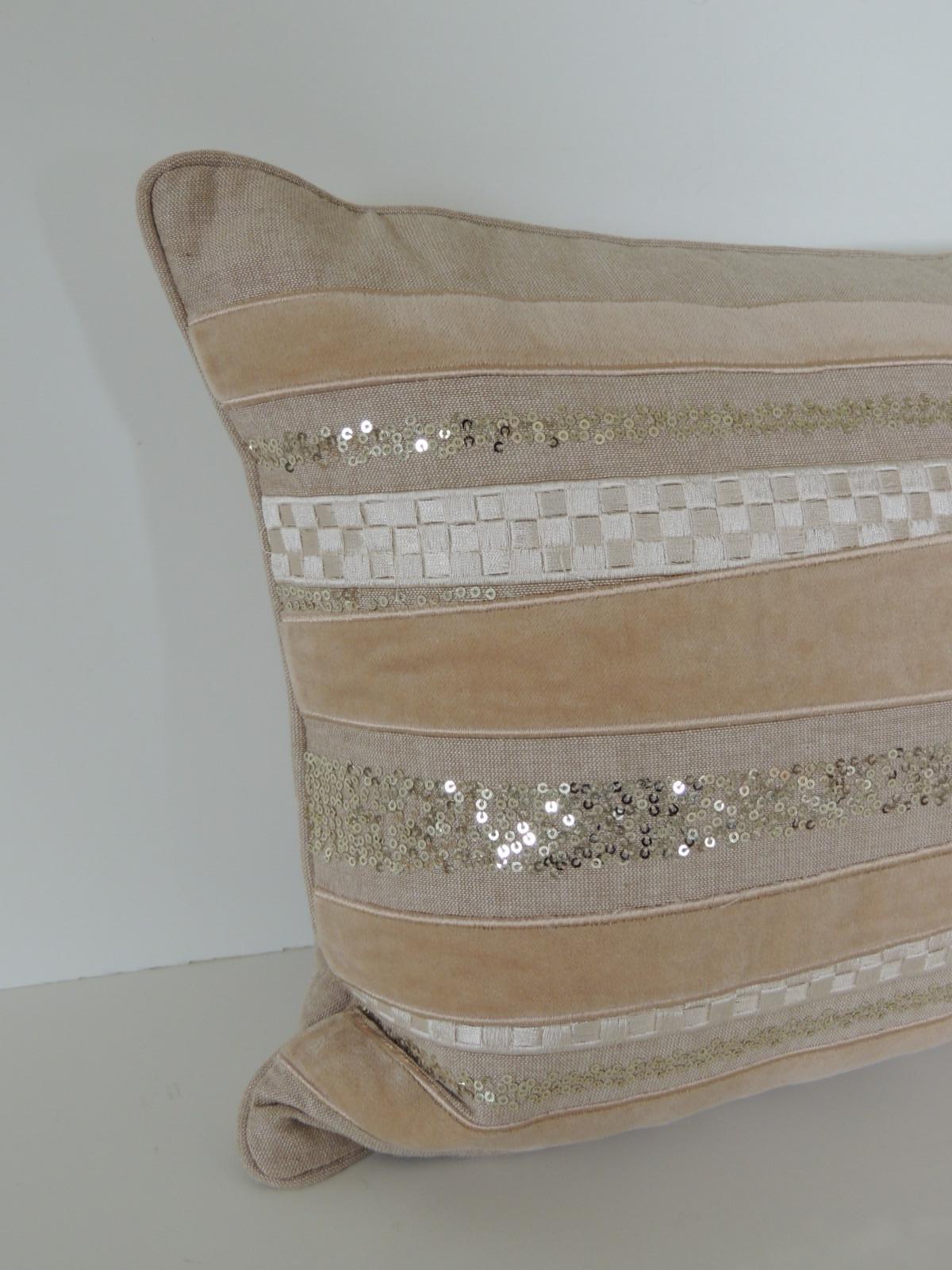 Tan and gold long bolster decorative pillow by Celerie Kemble.
Celerie linen pillow with woven applique ribbon design and small embroidered
sequins. Double-sided. Zipper closure, feather/down insert.
Size: 13