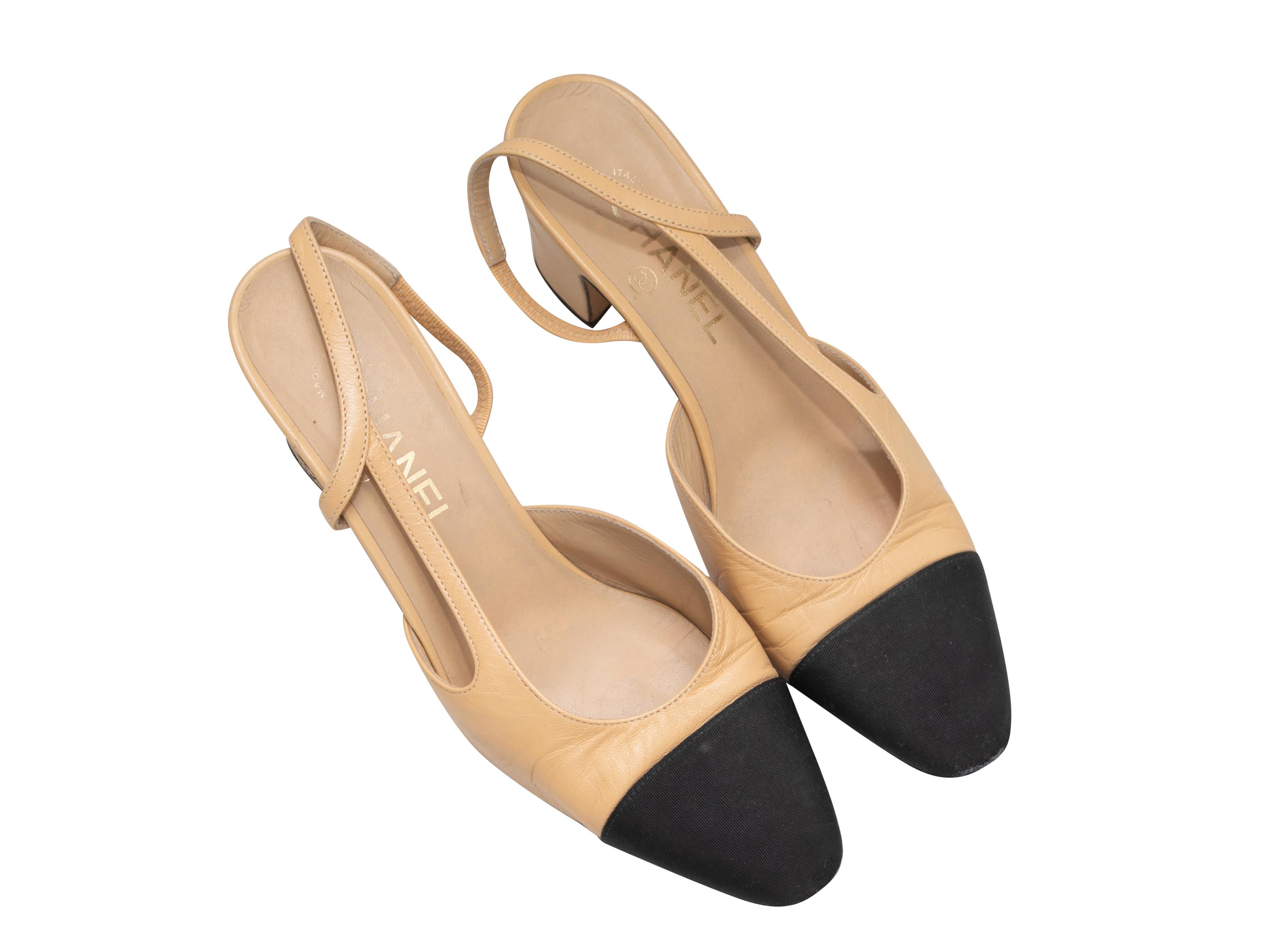 Tan and black leather cap-toe slingback pumps by Chanel. 2.5