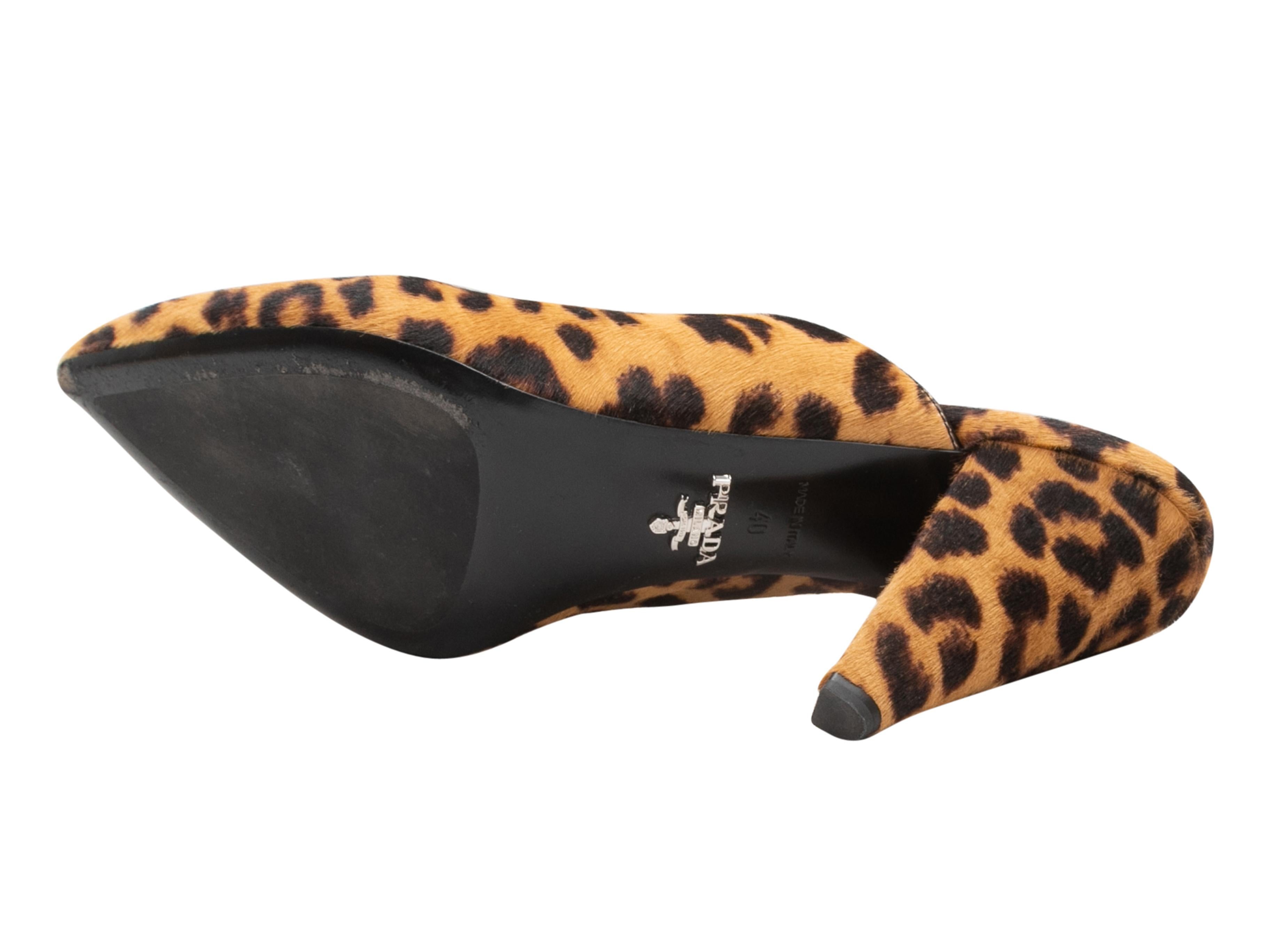 Tan and black leopard print pointed-toe ponyhair mules by Prada. 4