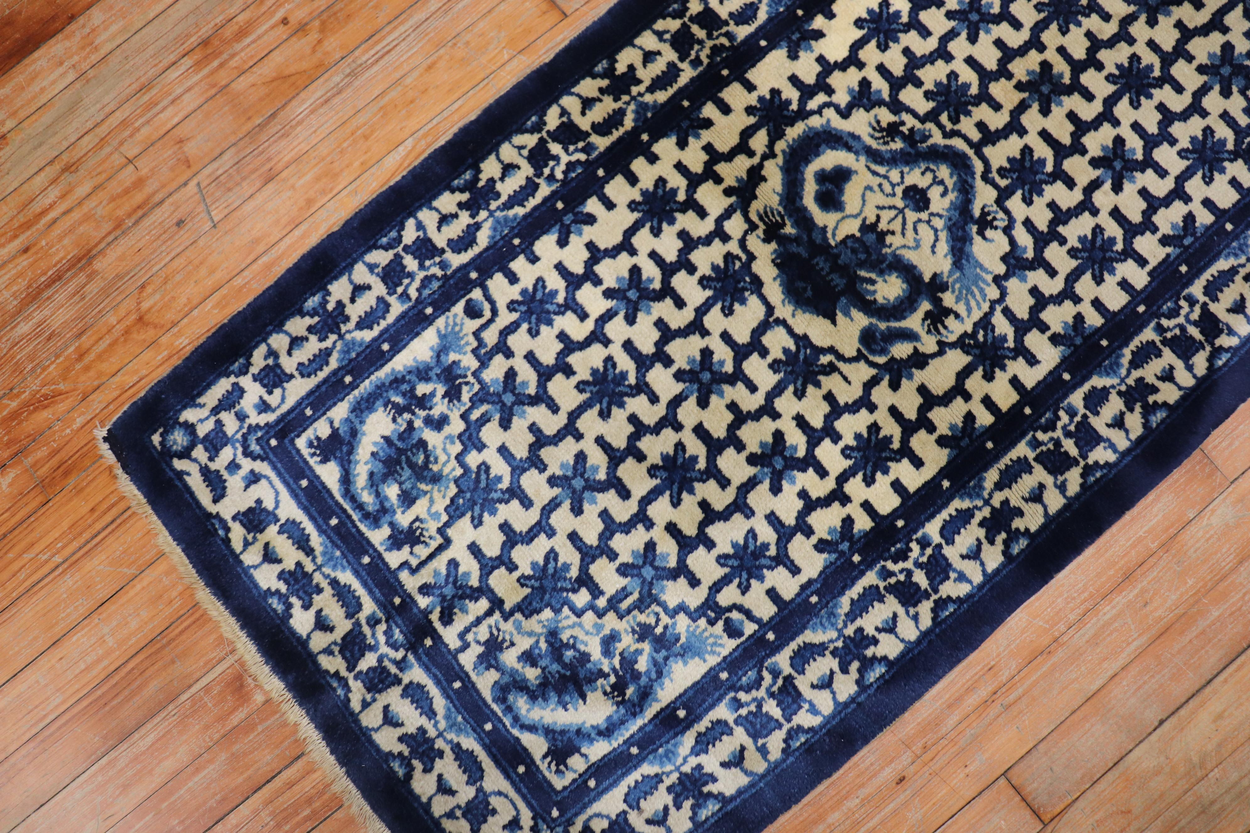 A mid-20th century floral Chinese rug in beige and navy blue with a dragon motif medallion.

Size: 2'3