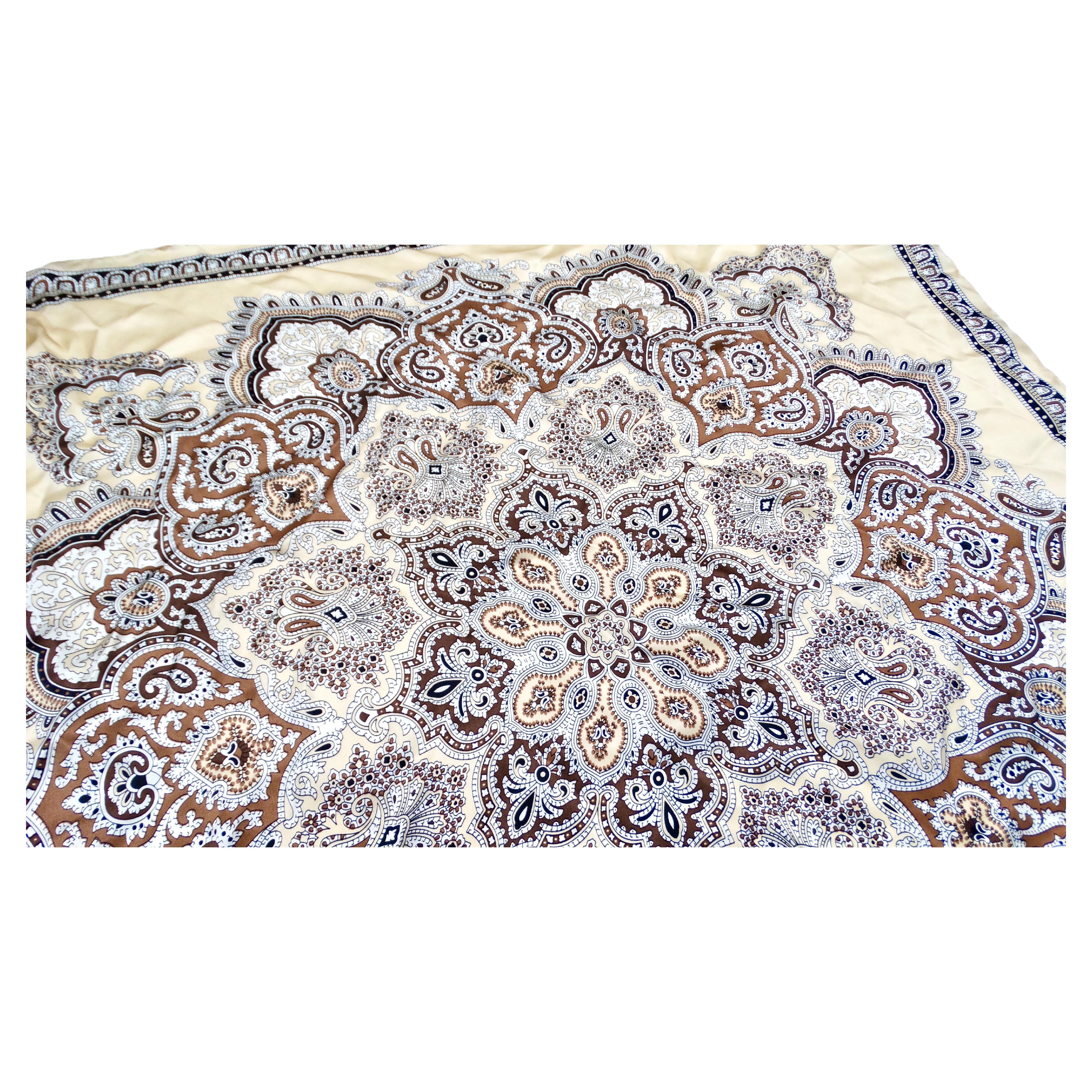 The Tan Bohemian Paisley Bandana Print Silk Scarf is a versatile accessory that effortlessly combines bohemian charm with sophisticated elegance. Crafted from luxurious silk, it features a timeless paisley pattern in warm shades of tan, brown,
