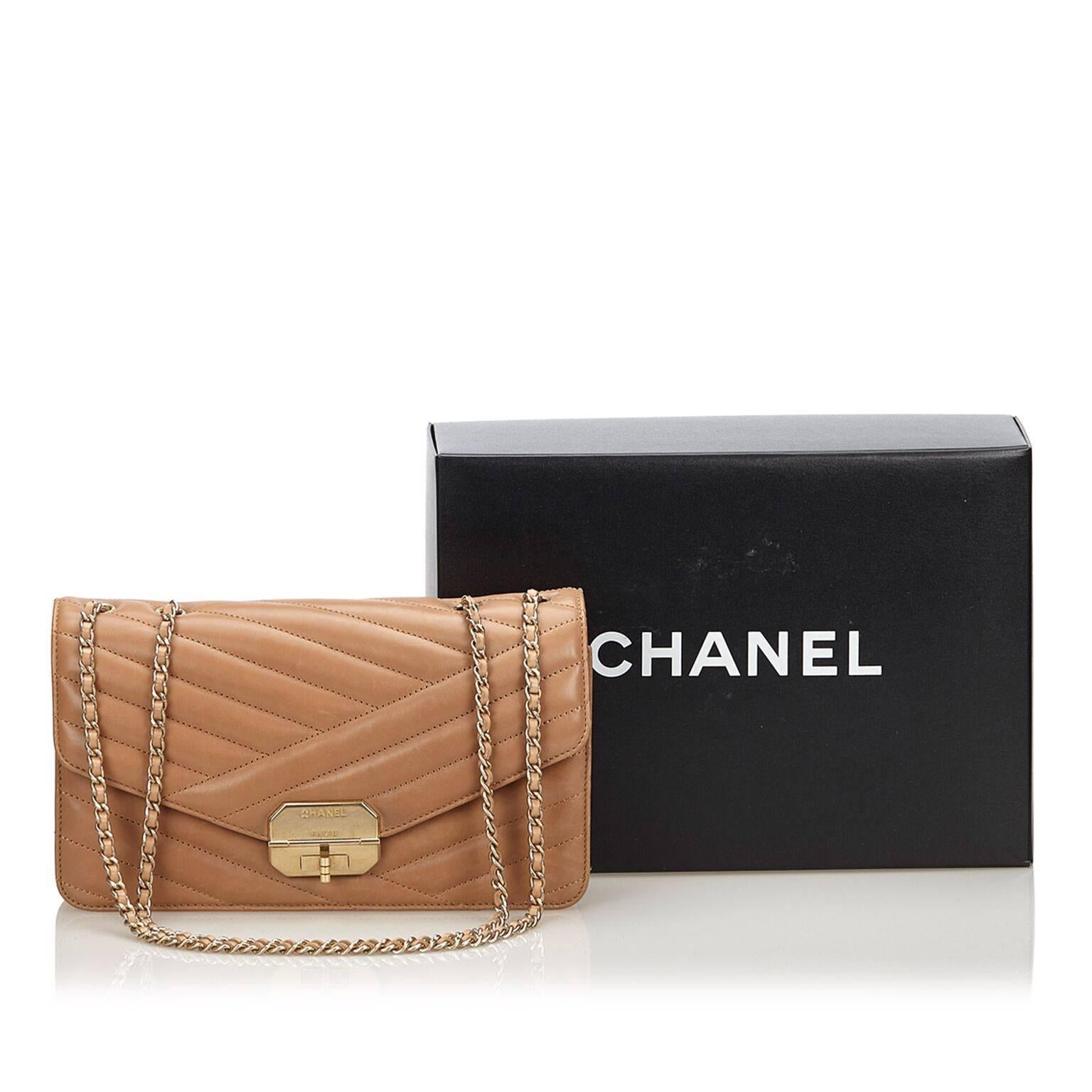 Product details:  Tan medium calfskin leather Gabrielle flap bag by Chanel.  Front flap with twist-lock closure.  Lined interior with zip pocket.  Back exterior slide pocket.  Goldtone hardware.  10