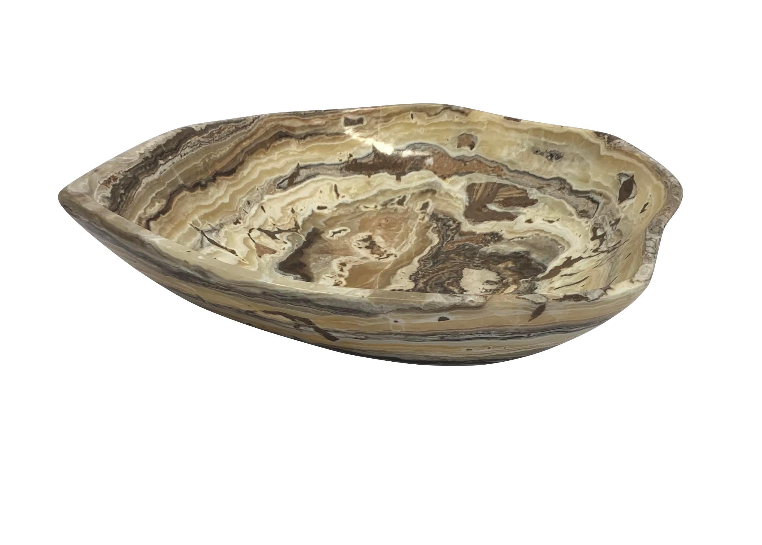 Contemporary Moroccan free form shaped onyx bowl.
Tan, cream and dark grey in color.
From a large collection of different shapes, sizes and colors.