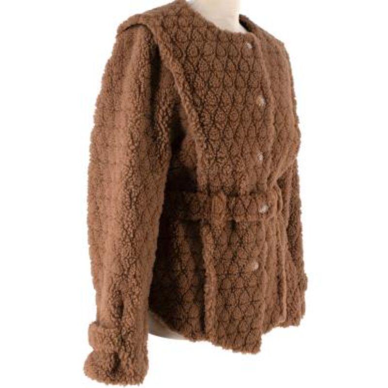 Chanel Tan diamond-shaved shearling jacket
 

 - Short pile teddy-style shearling with the iconic diamond 'quilting' shaved into the surface of the fur
 - Collarless, slightly boxy silhouette, with seamed shoulder giving a tabard appearance 
 -