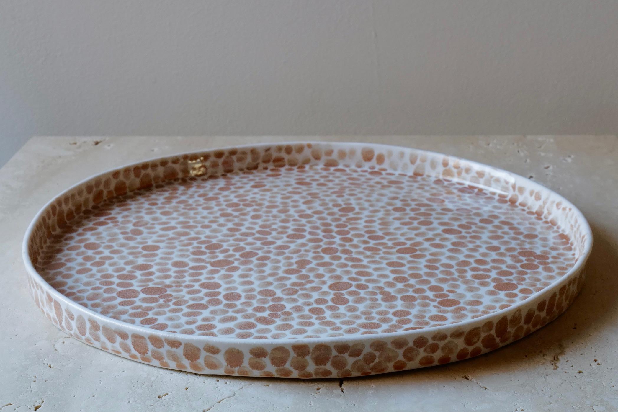 Large ceramic tray or serving platter. Hand-cast in porcelain and once bisque fired, each dot is hand-painted with a tan glaze. An unconventional layered glazing technique, developed by the artist, is used in these cast porcelain pieces. The