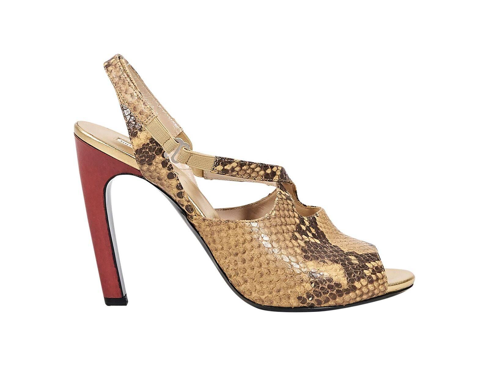 Product details:  Tan snakeskin pumps by Dries van Noten.  Slingback strap with inset elastic panels.  Peep toe.  Red heel.  Slip-on style.
Condition: Pre-owned. Very good.
Est. Retail $898