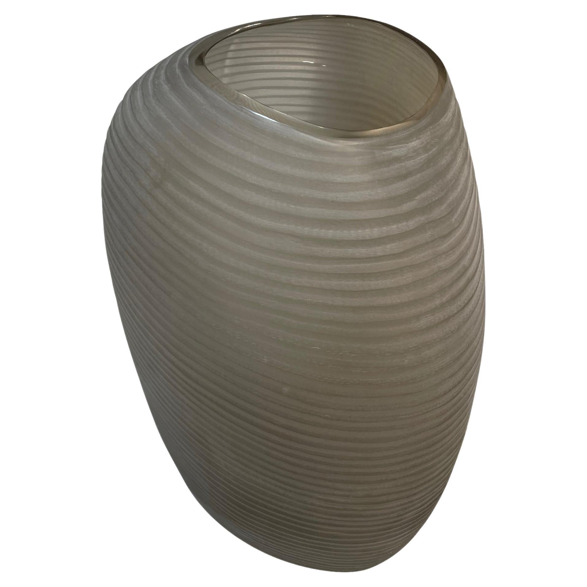 Contemporary Romanian frosted tan glass vase with horizontal ribbed design.
Can hold water.
From a collection of five frosted tan glass vases.
