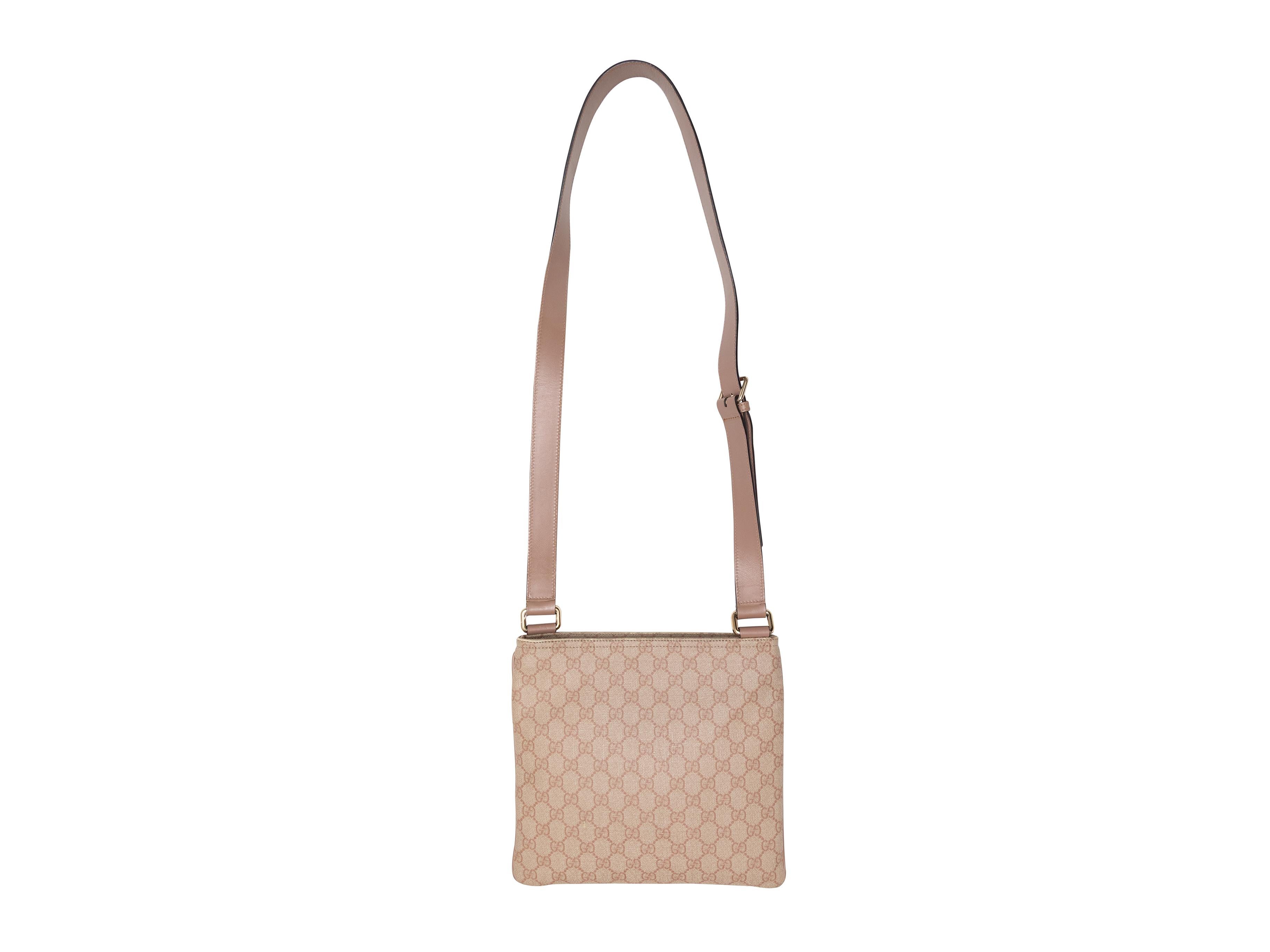 Tan Gucci GG Supreme Crossbody Bag. This crossbody bag features a GG Supreme body, silver-tone hardware, a front zip pocket, a single crossbody strap, and a top zip closure. 11.25