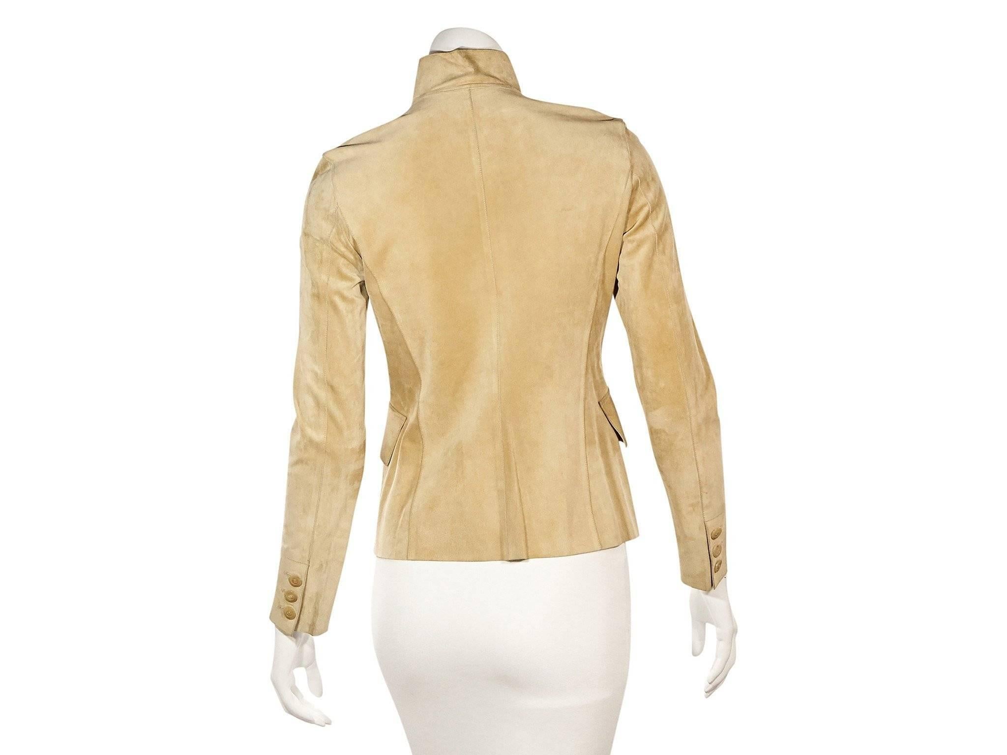 Product details: Tan suede jacket by Gucci. From the Tom Ford design era. Stand point collar. Long sleeves. Three-button detail at cuffs. Button-front closure. Flap waist pockets. 
Condition: Very good. 
Est. Retail $3,998