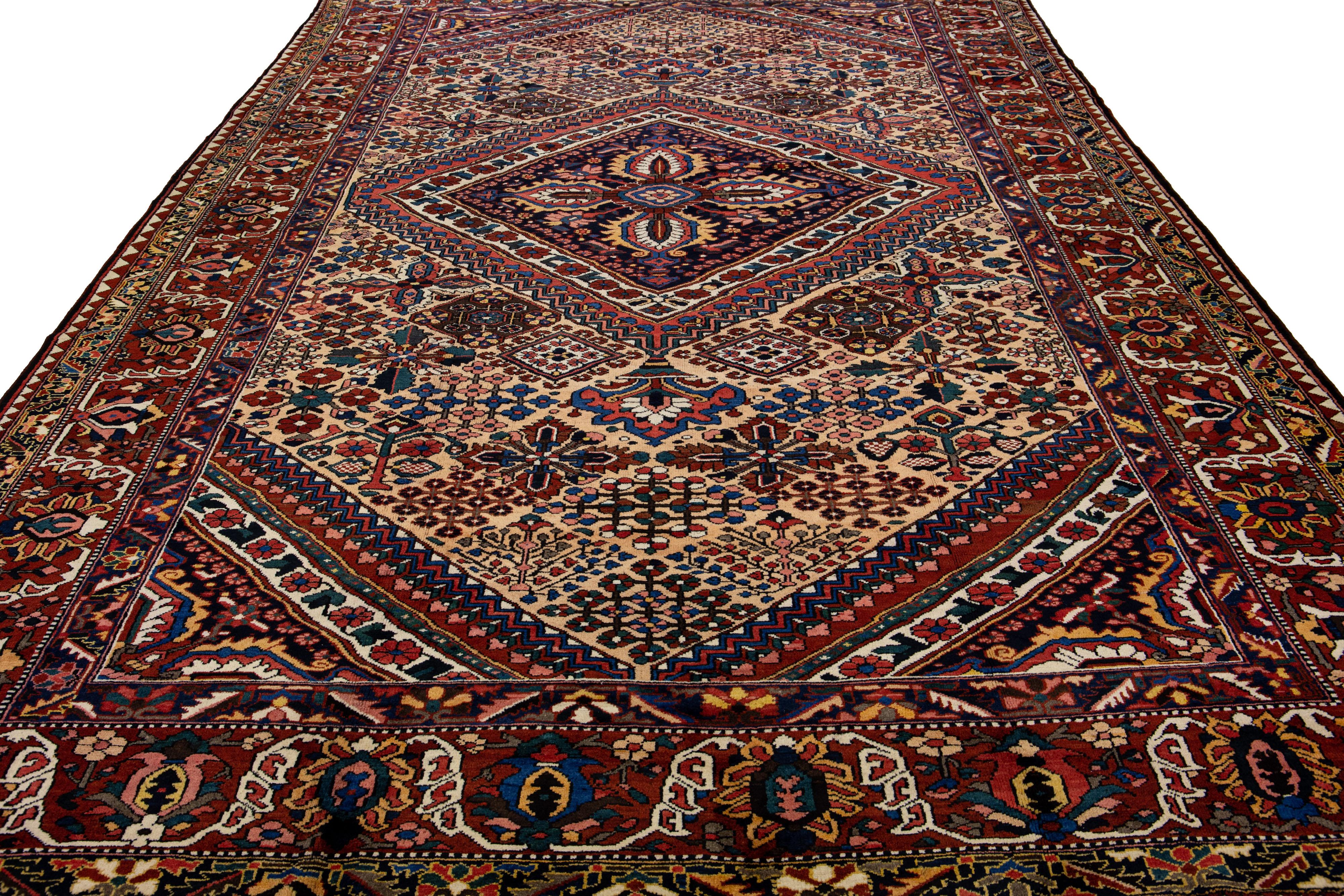 Beautiful Antique Bakhtiari hand-knotted wool rug with a tan color field. This Persian piece has an all-over multicolor accent in a gorgeous classic Medallion motif.

This rug measures 11'5