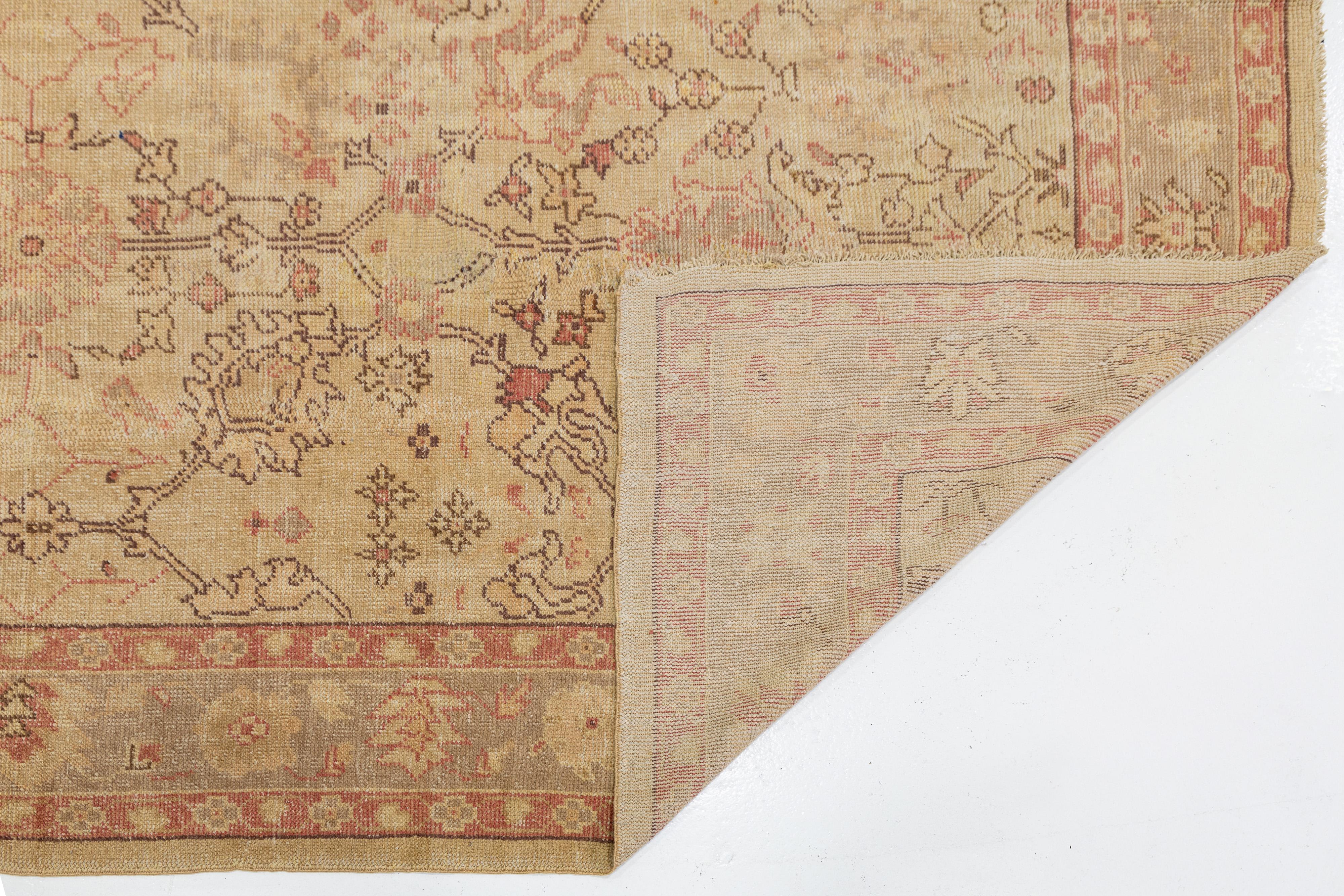 Hand-Knotted Tan Handmade Turkish Oushak Wool Rug Featuring a Floral Motif For Sale
