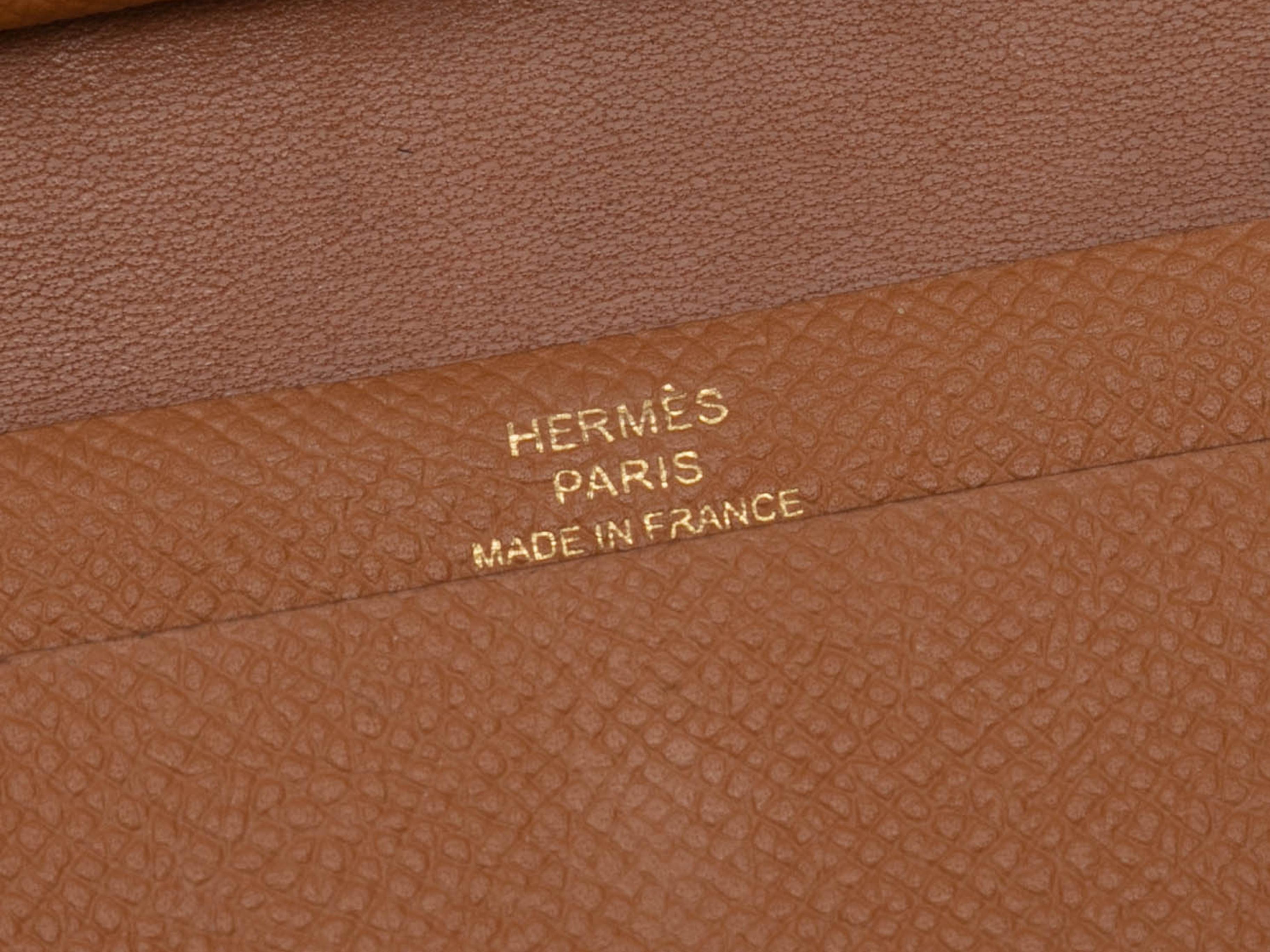 Tan Mini Bearn leather wallet by Hermes. Gold-tone hardware. Contrast stitching. Front closure. 3