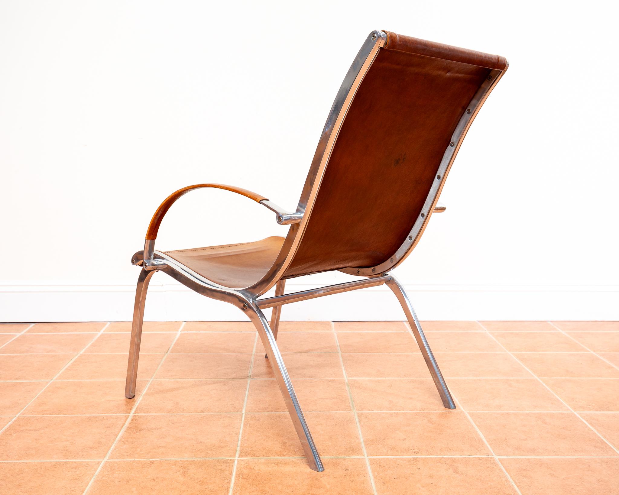 A strikingly attractive tan leather and aluminium Mid Century Hungarian armchair in lovely vintage condition. Designed by Rudolf Szedleczky and made in the early 1970s, this extremely comfortable lounge chair will enhance any interior with its super