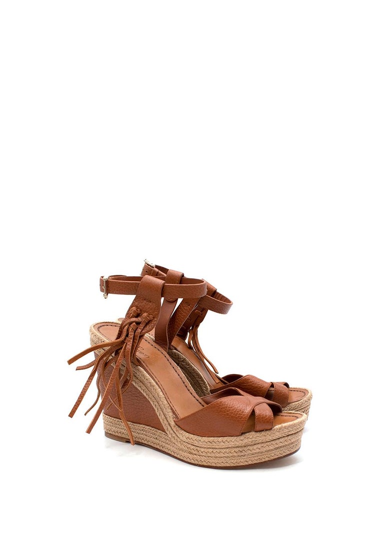 Valentino Tan Leather & Jute Wedge Heeled Espadrille Sandals

- High woven jute wedge heel, contrasting with a rich tan-brown leather upper
- Crossover foot strap, and adjustable buckled ankle strap 
- Braided tassel decoration