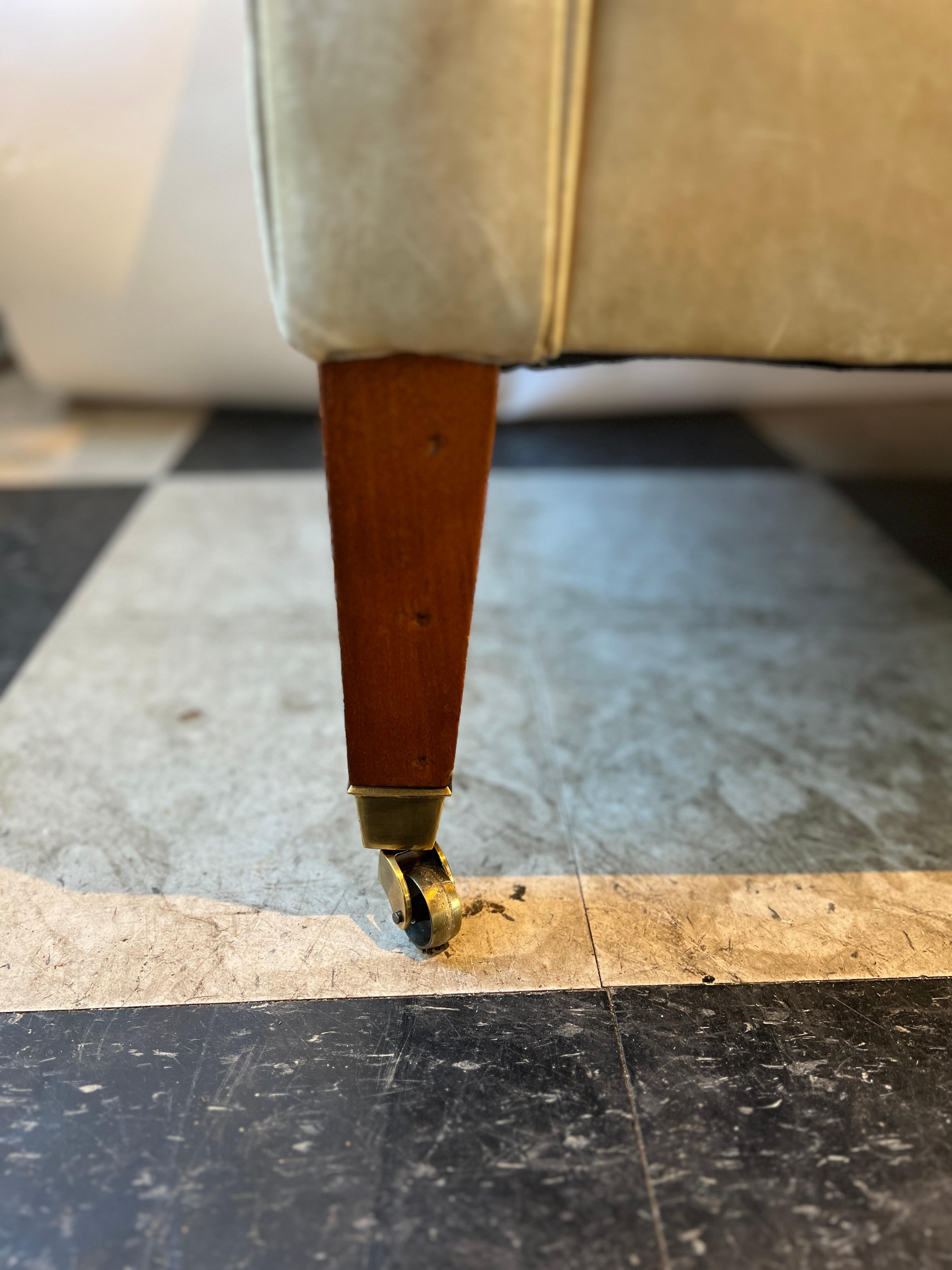 Ralph Lauren leather couch on brass casters for Henredon. Foam and 50% down cushions. Leather beautifully faded from the sun. The sun has turned the leather into different shades of tan.  On the left side of the couch there looks like there is a