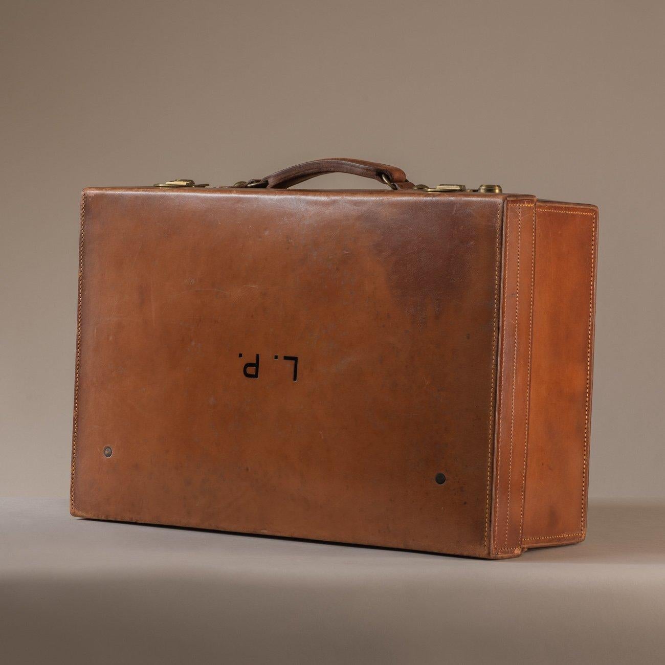 An attractive tan leather case that would have originally held a range of fittings. Constructed in veg-tanned, heavy-gauge, hand-stitched cow-hide with sturdy brass catches. Initialled LP to the top of the case. The front lip of the case interior