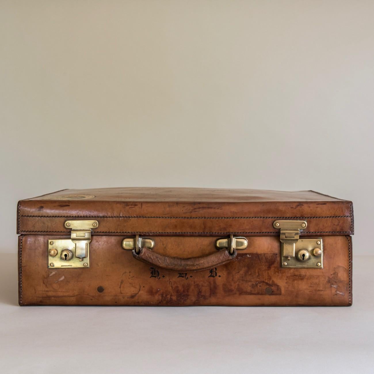 A fine Brachers of Bristol and Cardiff suitcase circa 1900 in veg-tanned, heavy-gauge, hand-stitched cow-hide. 
This is a good example of their superb luggage, the best of British craftsmanship. The case has been well used and has developed a lovely