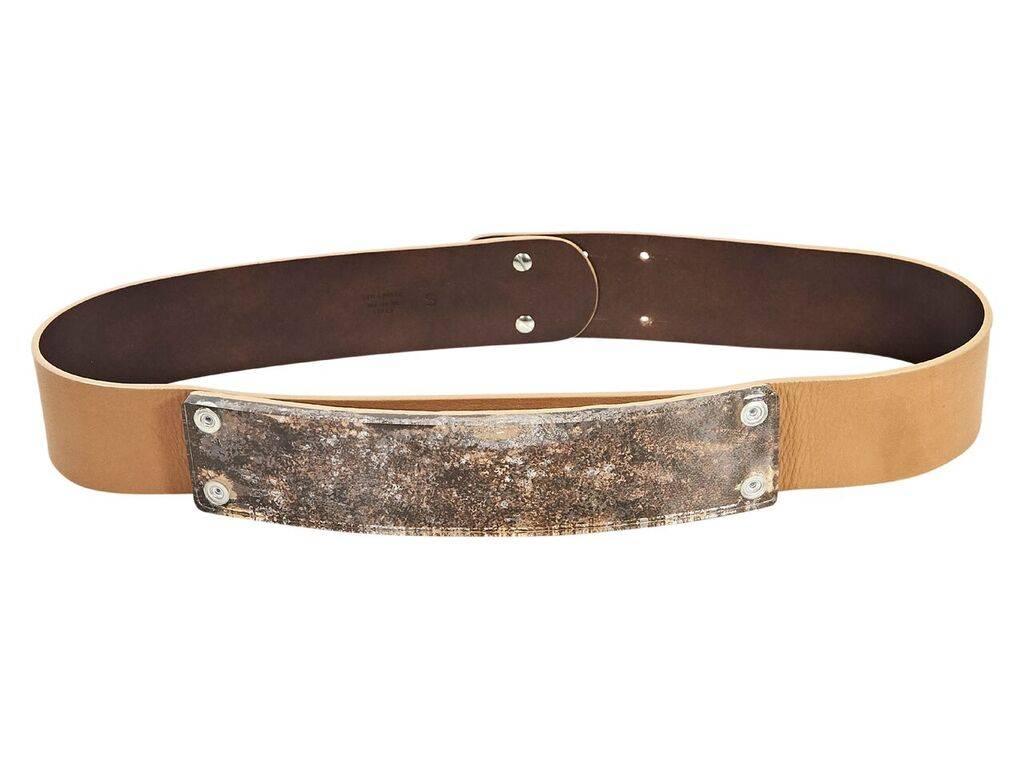 Product details:  Tan leather belt by Maison Margiela.  Plastic front plaque.  Adjustable double pin closure.  Silvertone hardware.  30