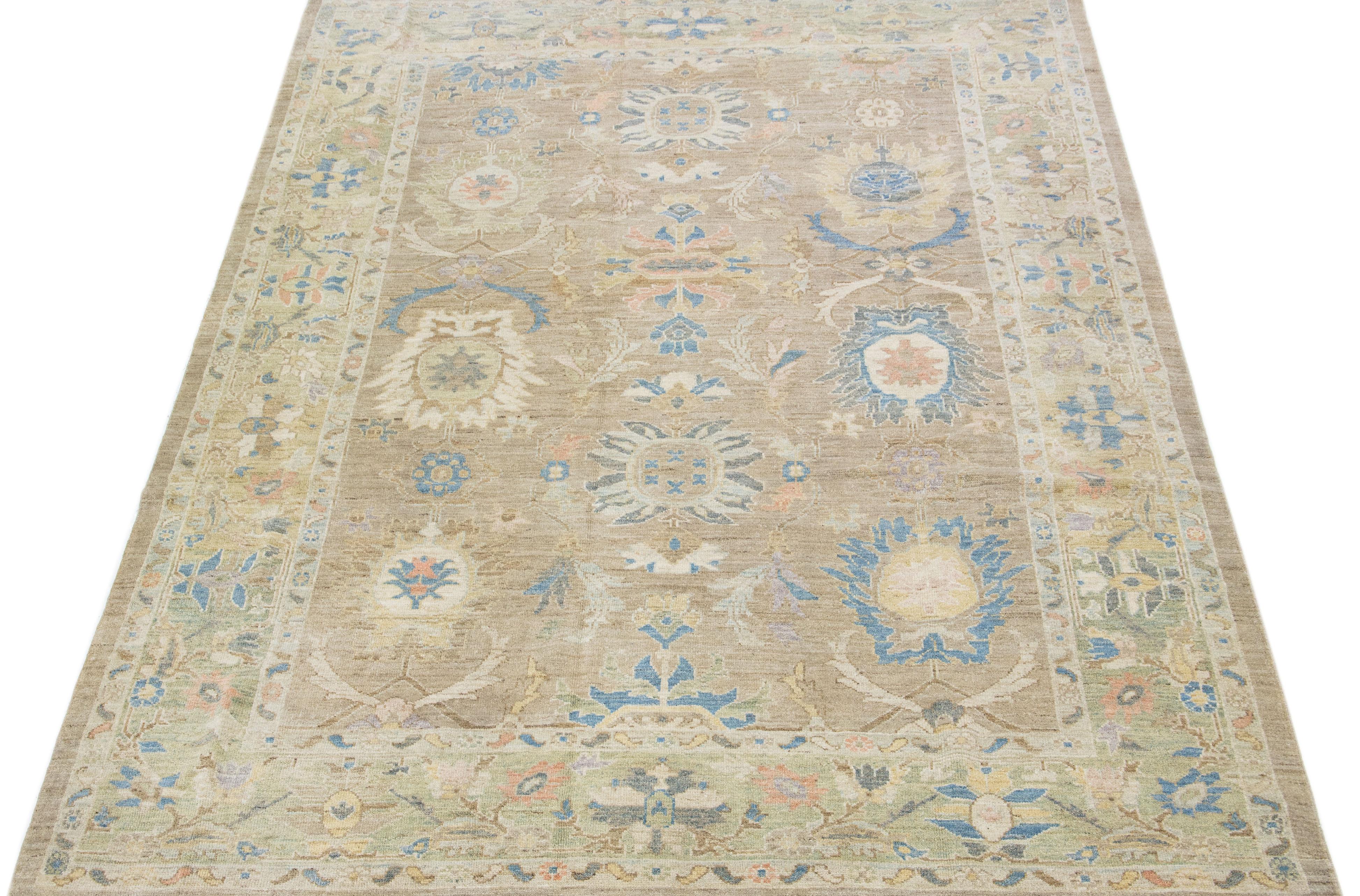 Beautiful modern Sultanabad hand knotted wool rug with a tan color field. This rug has a green-designed frame with multicolor accents in a gorgeous all-over floral design.

This rug measures: 8'11