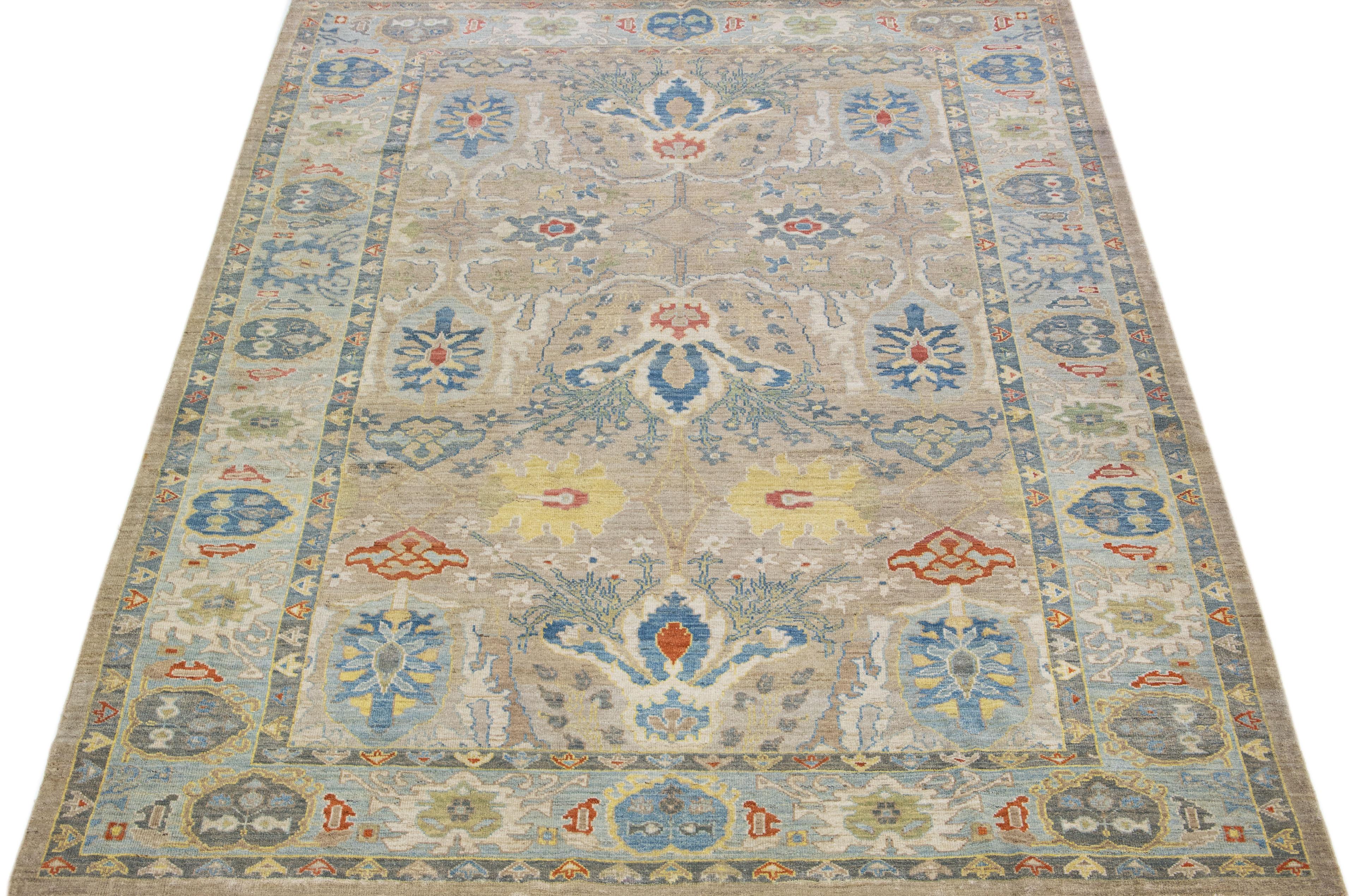 Beautiful modern Sultanabad hand-knotted wool rug with a tan color field. This rug has a blue-designed frame with multicolor accents in a gorgeous all-over floral design.

This rug measures: 8'7