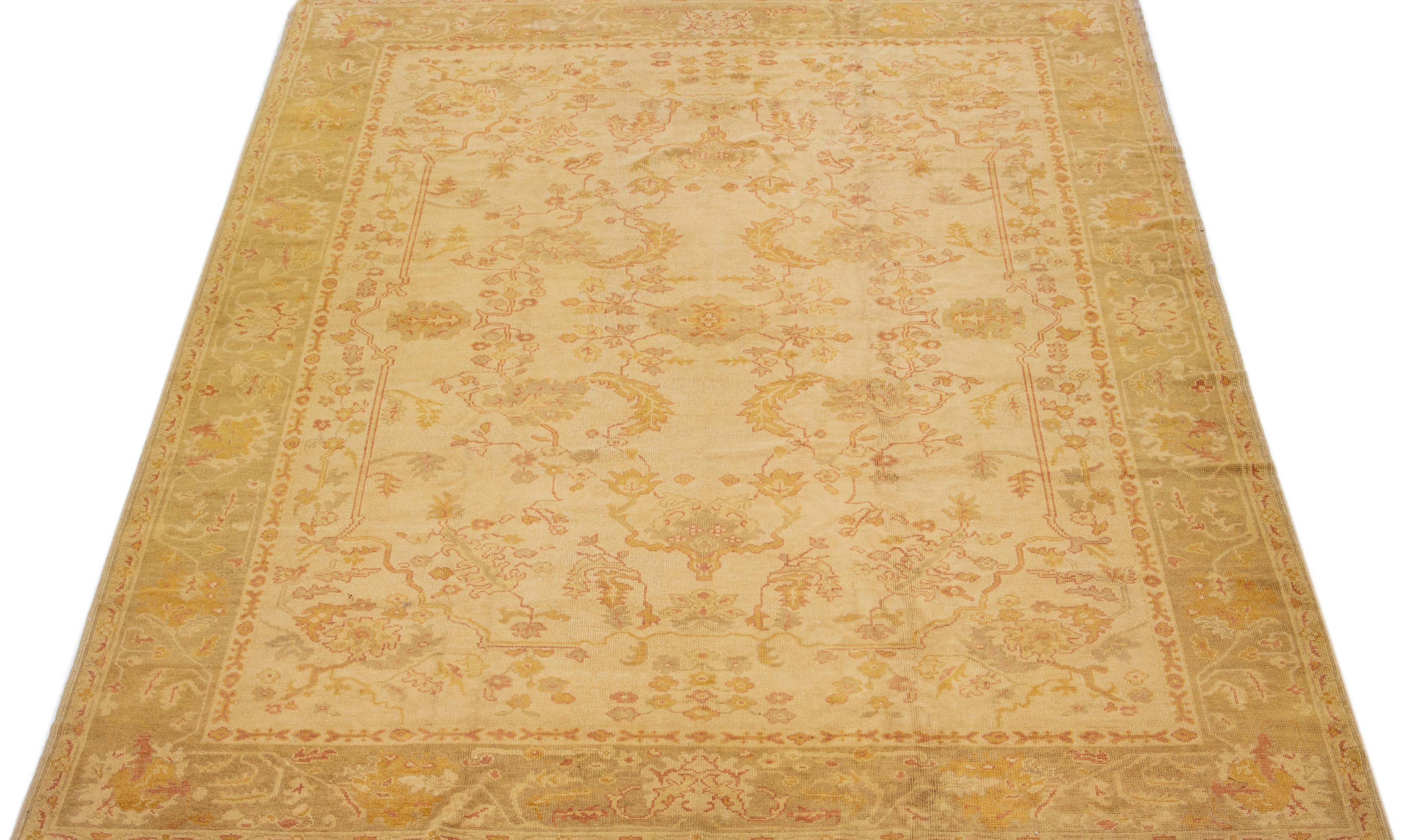 Beautiful Modern Turkish hand-knotted wool rug with a tan color field. This rug has a gray designed frame with accent colors of rust and yellow in a gorgeous all-over geometric floral design.

This rug measures: 10'3