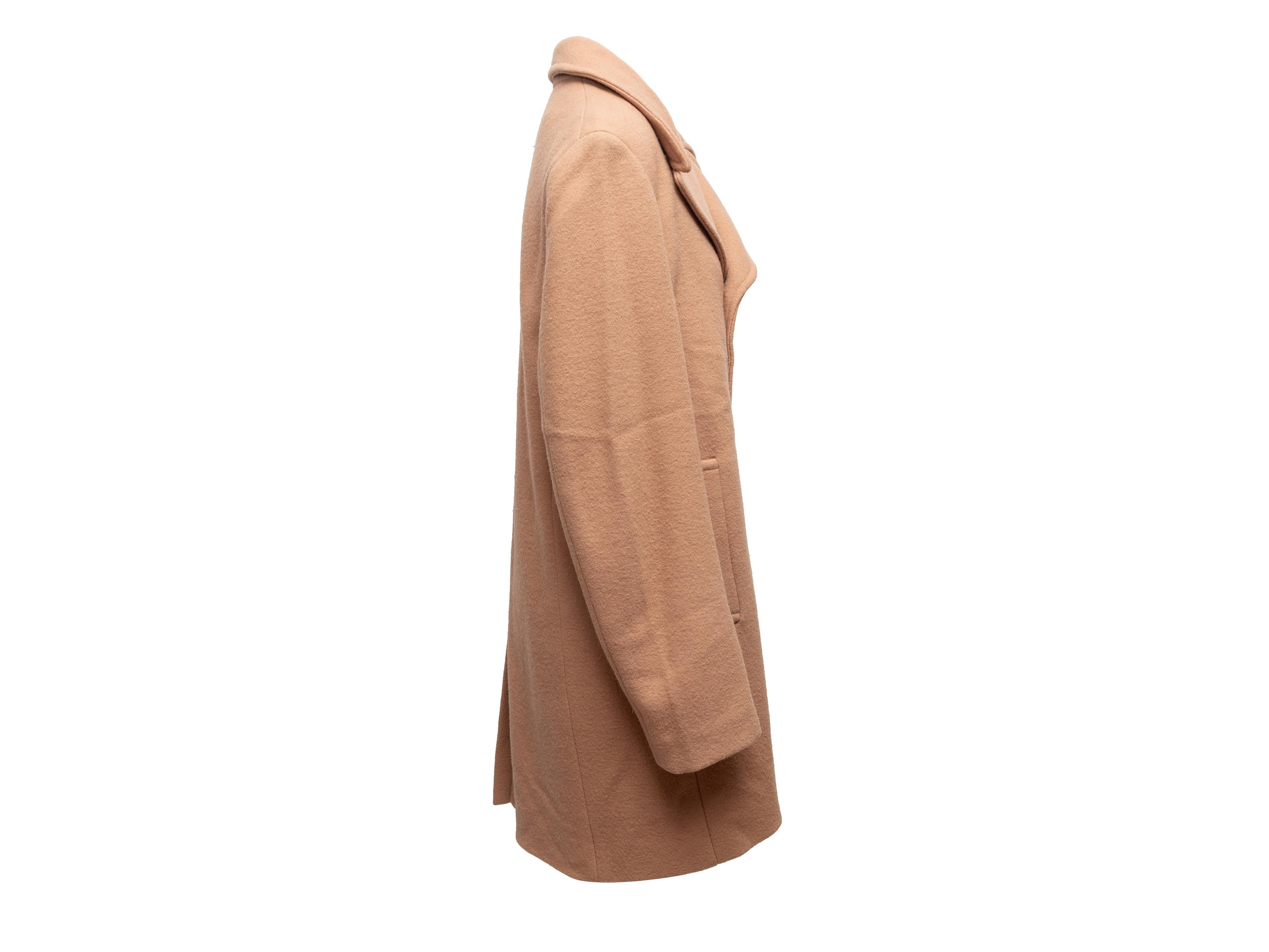 Tan wool double-breasted coat by Phillip Lim. Detachable rabbit fur lining. Notched lapel. Dual hip pockets. Button closures at front. 40