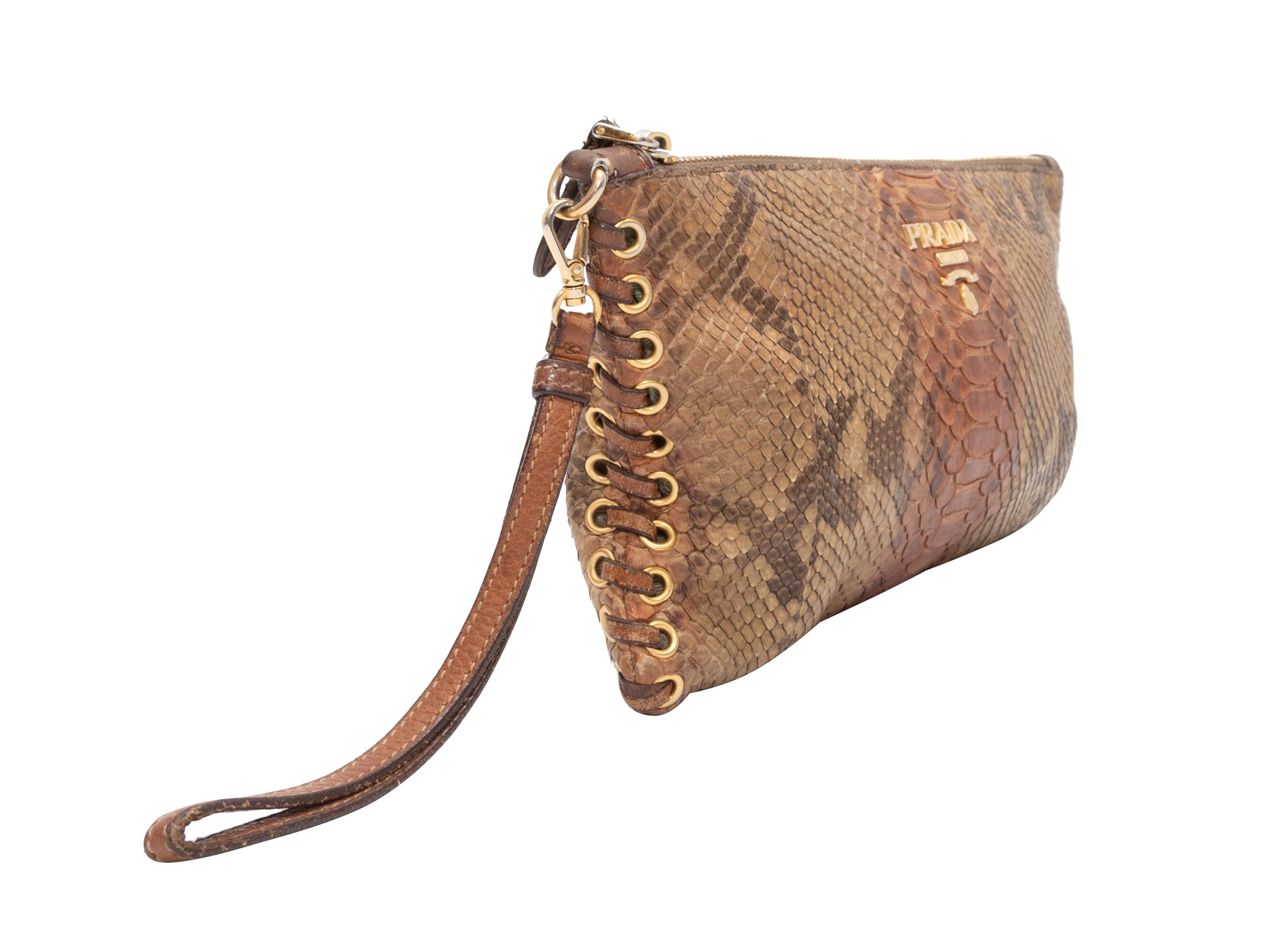 Product Details: Tan Prada Snakeskin Wristlet Clutch. This clutch features a snakeskin body, gold-tone hardware, nylon interior, optional wristlet strap, and a top zip closure. 10