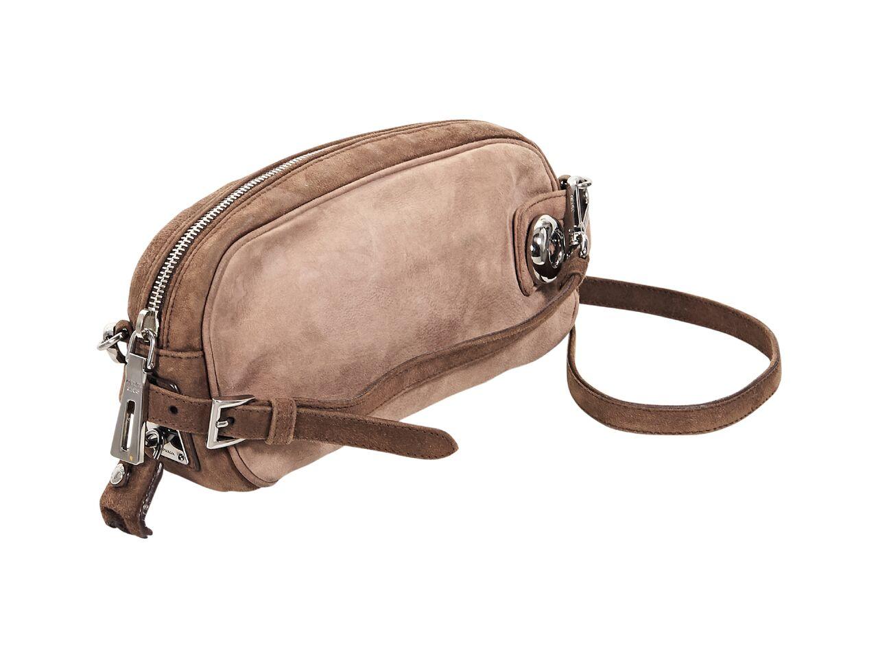 Product details:  Tan suede Scamosciato crossbody bag by Prada.  Detachable, adjustable crossbody strap.  Top zip closure with lock and key.  Leather lined interior with inner zip pocket.  Silvertone hardware.  8.5