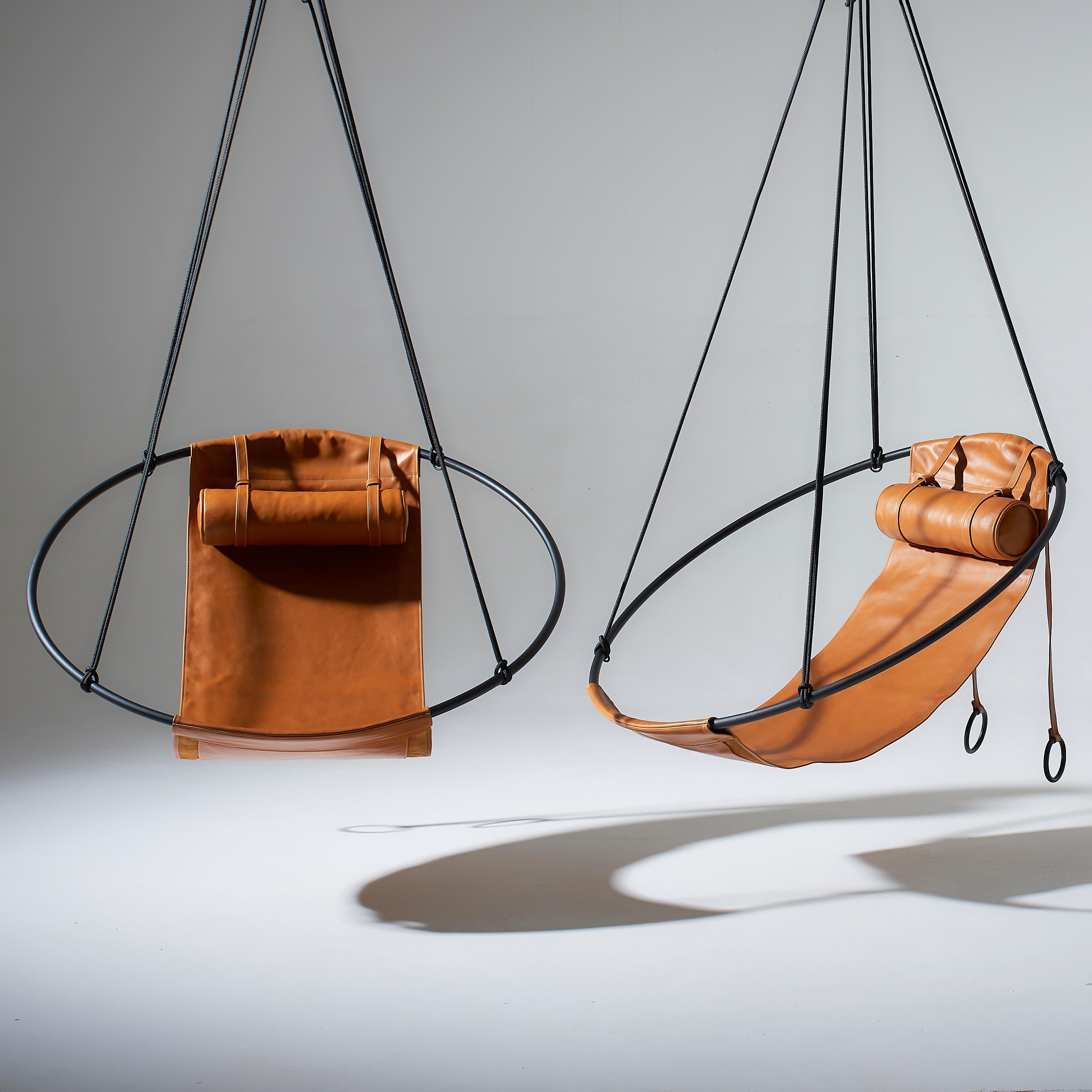 Stripped away from all excess, this hanging chair has a circular frame with the sheets of soft leather hanging loose within it, to create a sleek, sexy, and oh so comfortable experience. This chair’s clean lines and lightness makes it a perfect fit