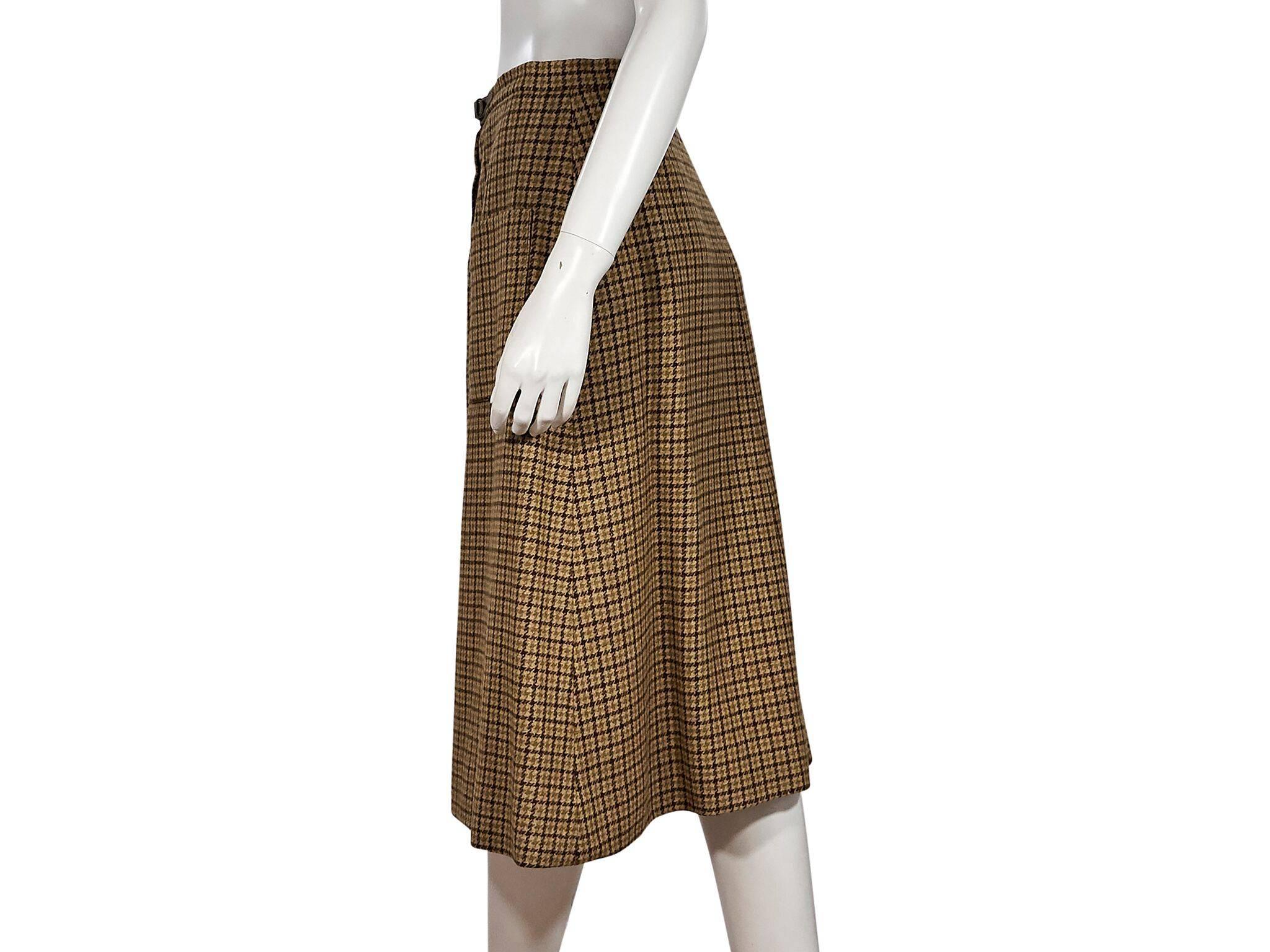 Product details:  Vintage tan wool A-line skirt by Hermes.  Leather belted accent.  Zip-front closure.  Front patch pockets.  Label size FR 42.  30