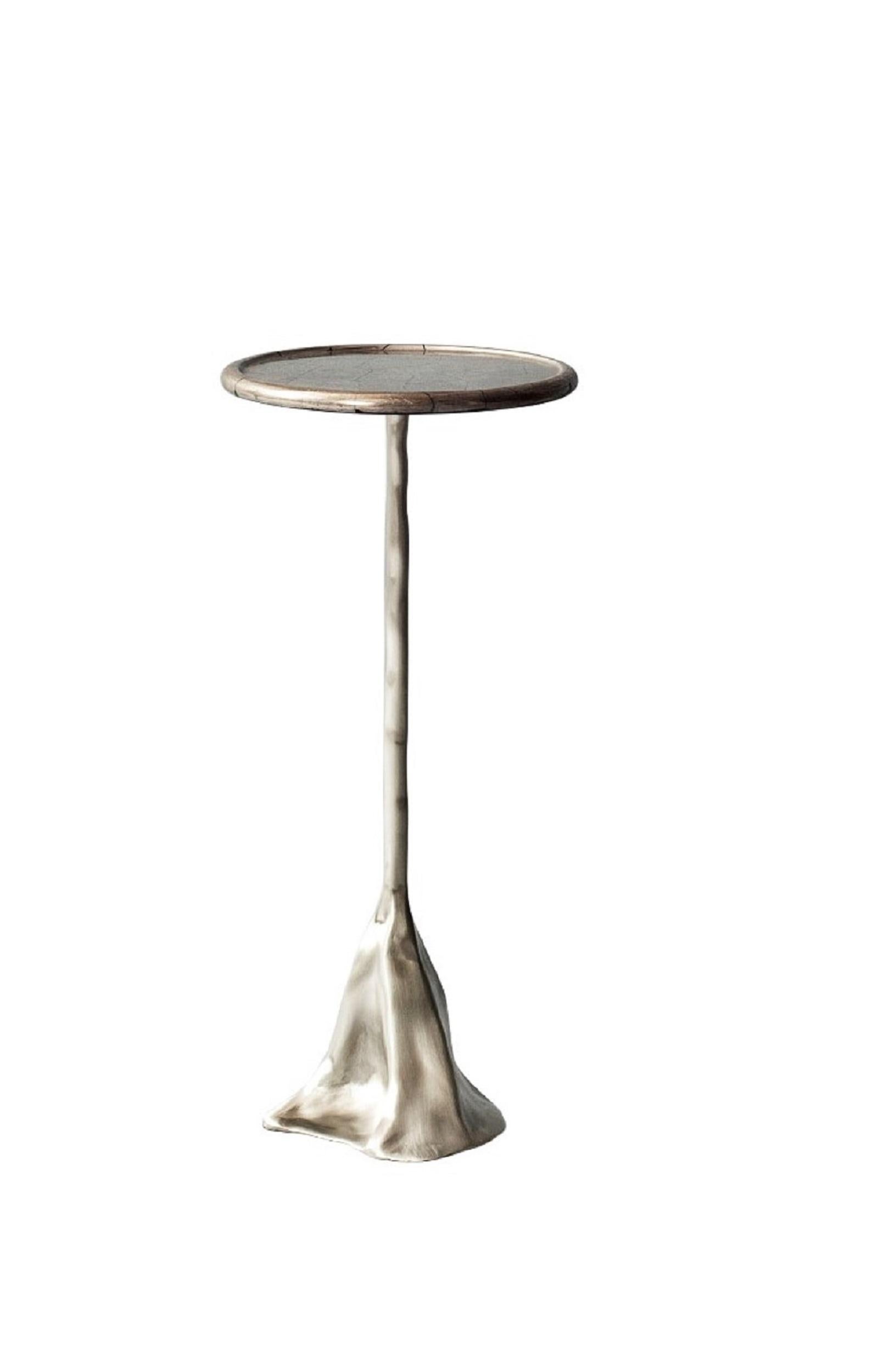 Tana side table by DeMuro Das
Dimensions: 25 x H 55.6 cm
Materials: Pyrite (Silver), polished (Random)
Solid Nickle silver, satin

Dimensions and finishes can be customized.

DeMuro Das is an international design firm and the aesthetic and