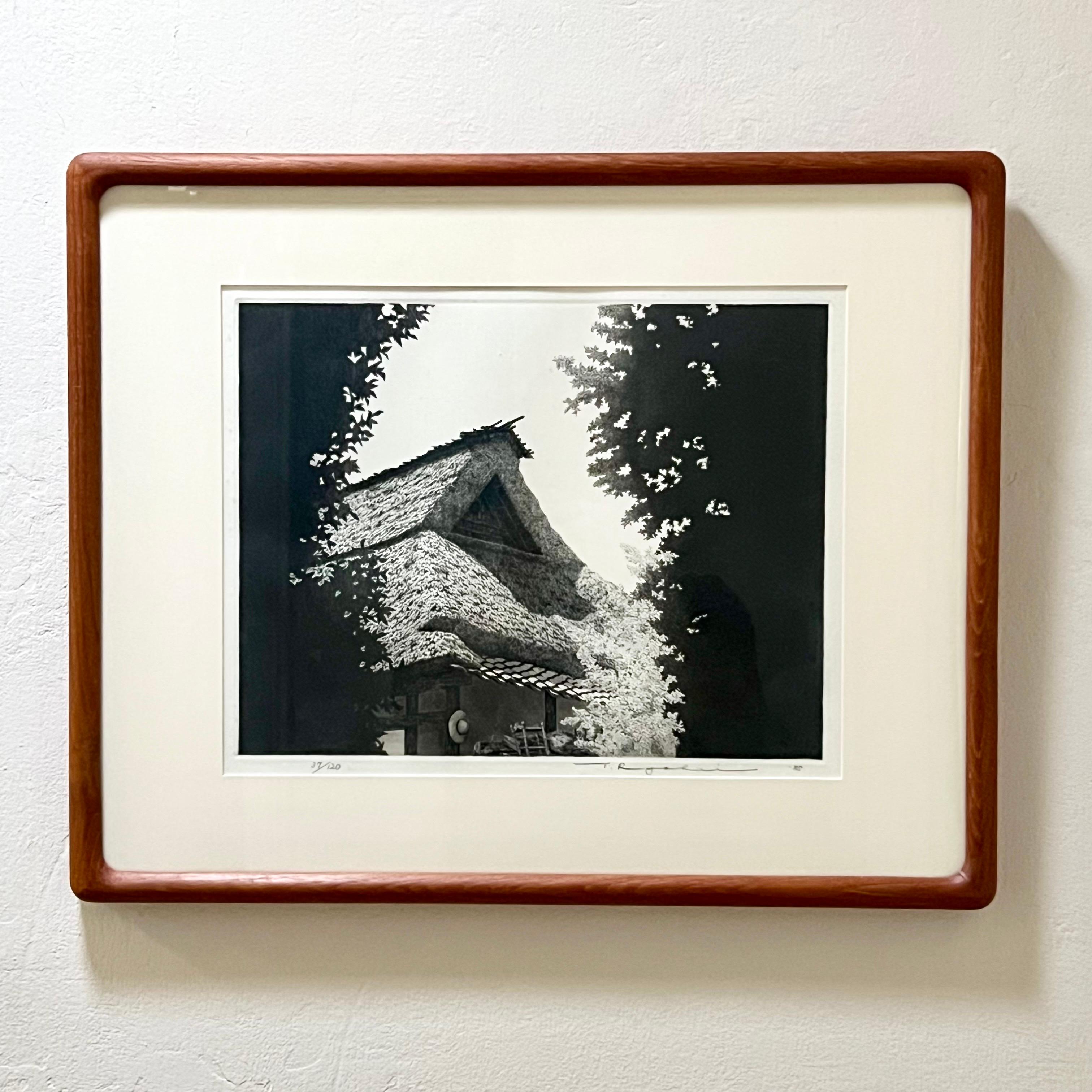 Stunning Ryohei Tanaka etching of a structure on the Japan countryside. Beautifully framed and matted in a custom rounded edge teak frame.

Ryohei Tanaka (1933-2019) was world renowned for his intricate black and white etchings of rural Japan. Born