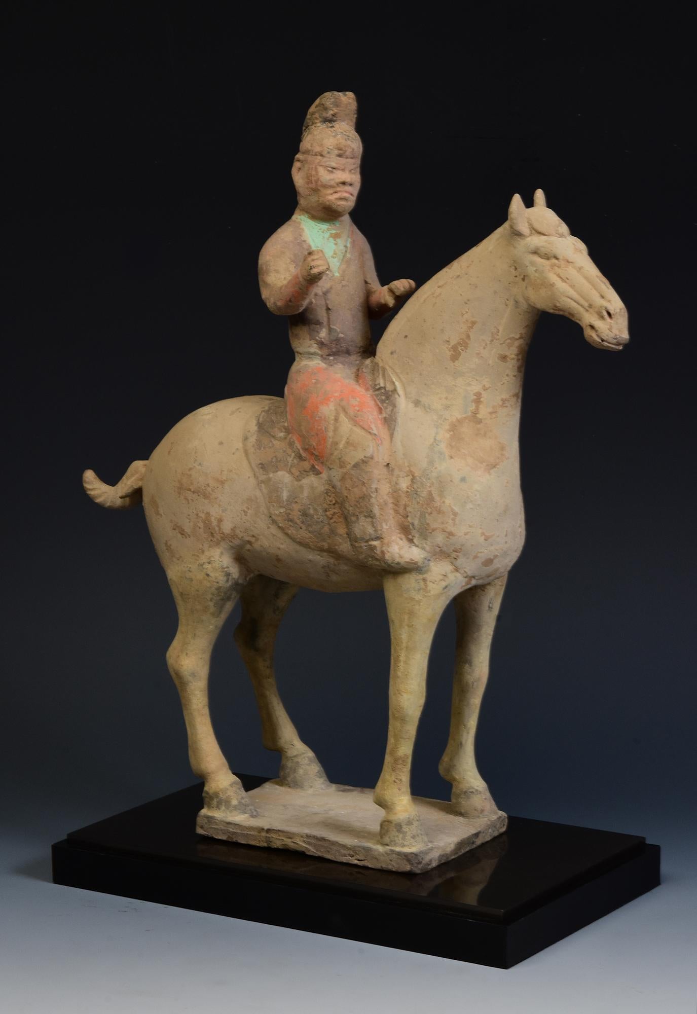 Antique Chinese painted pottery horse and rider.

Age: China, Tang Dynasty, A.D. 618 - 907
Size: Height 36 C.M. / Width 9.7 C.M. / Length 31.6 C.M. (size excluding stand)
Condition: Well-preserved old burial condition overall with some amount of