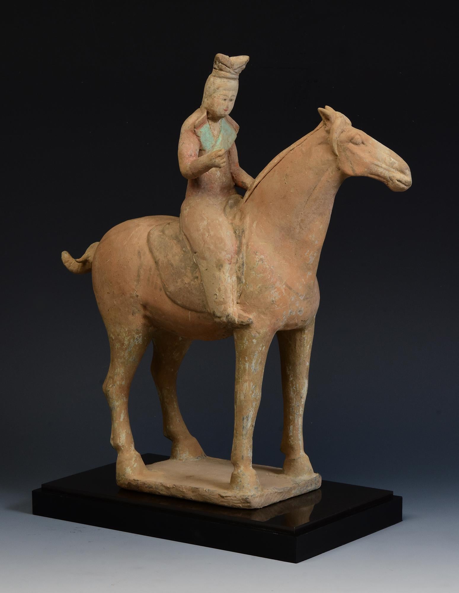 Antique Chinese painted pottery horse and rider.

Age: China, Tang Dynasty, A.D. 618 - 907
Size: Height 34.5 C.M. / Width 10 C.M.  / Length 32.7 C.M. (size excluding stand)
Condition: Well-preserved old burial condition overall with some amount of