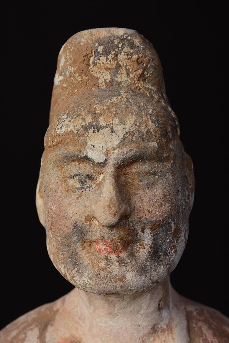 Chinese painted pottery standing foreign court man, bulging eyes, high nose, wearing hat, with red black, and white pigments remaining.

Age: China, Tang Dynasty, A.D. 618 - 907
Size: Height 37.7 C.M. / Width 11.3 C.M. (size excluding