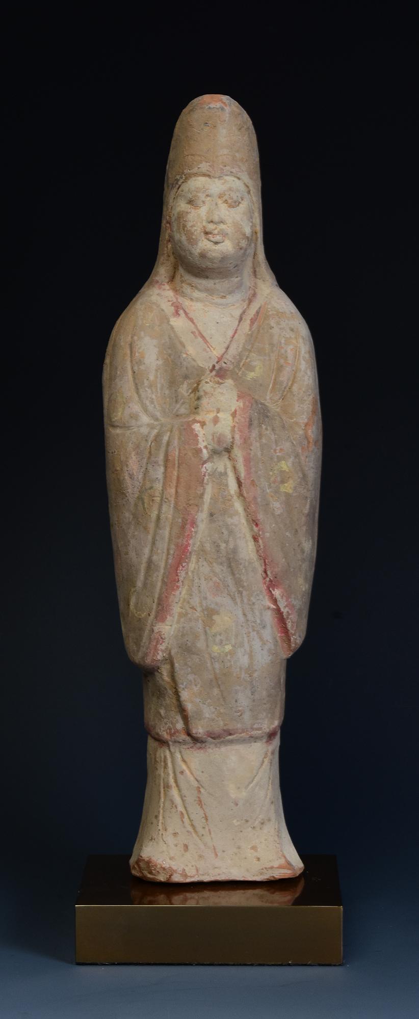 Antique Chinese pottery standing court man wearing hat and tunic.

Age: China, Tang Dynasty, A.D. 618 - 907
Size: Height 35.8 C.M. / Width 10 C.M. / Depth 8 C.M. (size excluding stand)
Condition: Well-preserved old burial condition overall with some