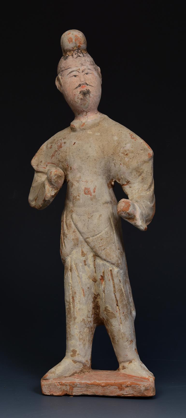 Chinese pottery standing groom figurine.

Age: China, Tang Dynasty, A.D. 618 - 907
Size: Height 27 C.M. / Width 10 C.M. / Thickness 5.7 C.M. (size excluding stand)
Condition: Well-preserved old burial condition overall with some amount of soil