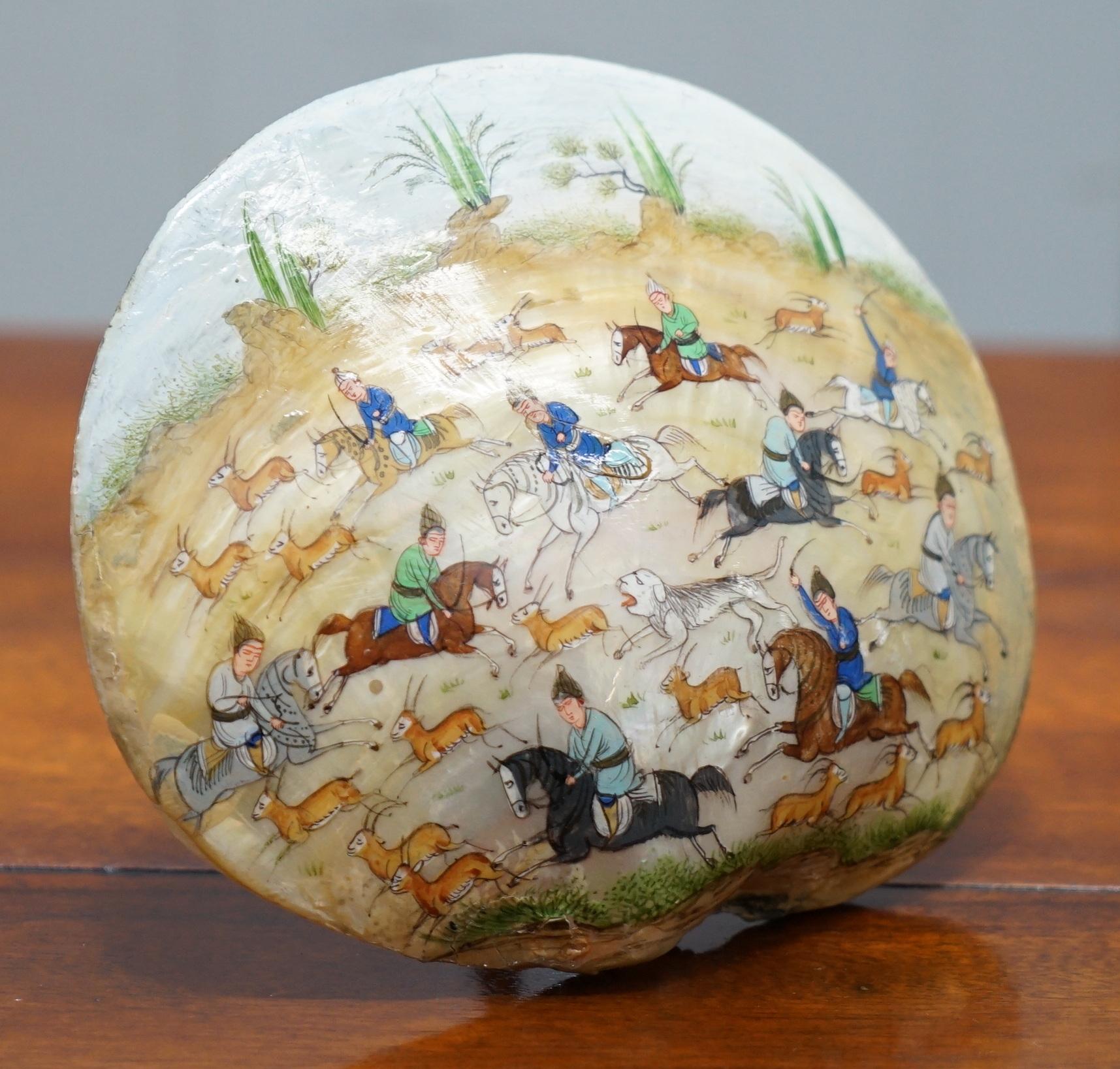 We are is delighted to offer for sale this lovely possibly 18th century mother of pearl shell which has been hand painted with a Tang dynasty deer hunting scene

A very rare find especially with this type of painting on.

Mine has a little metal