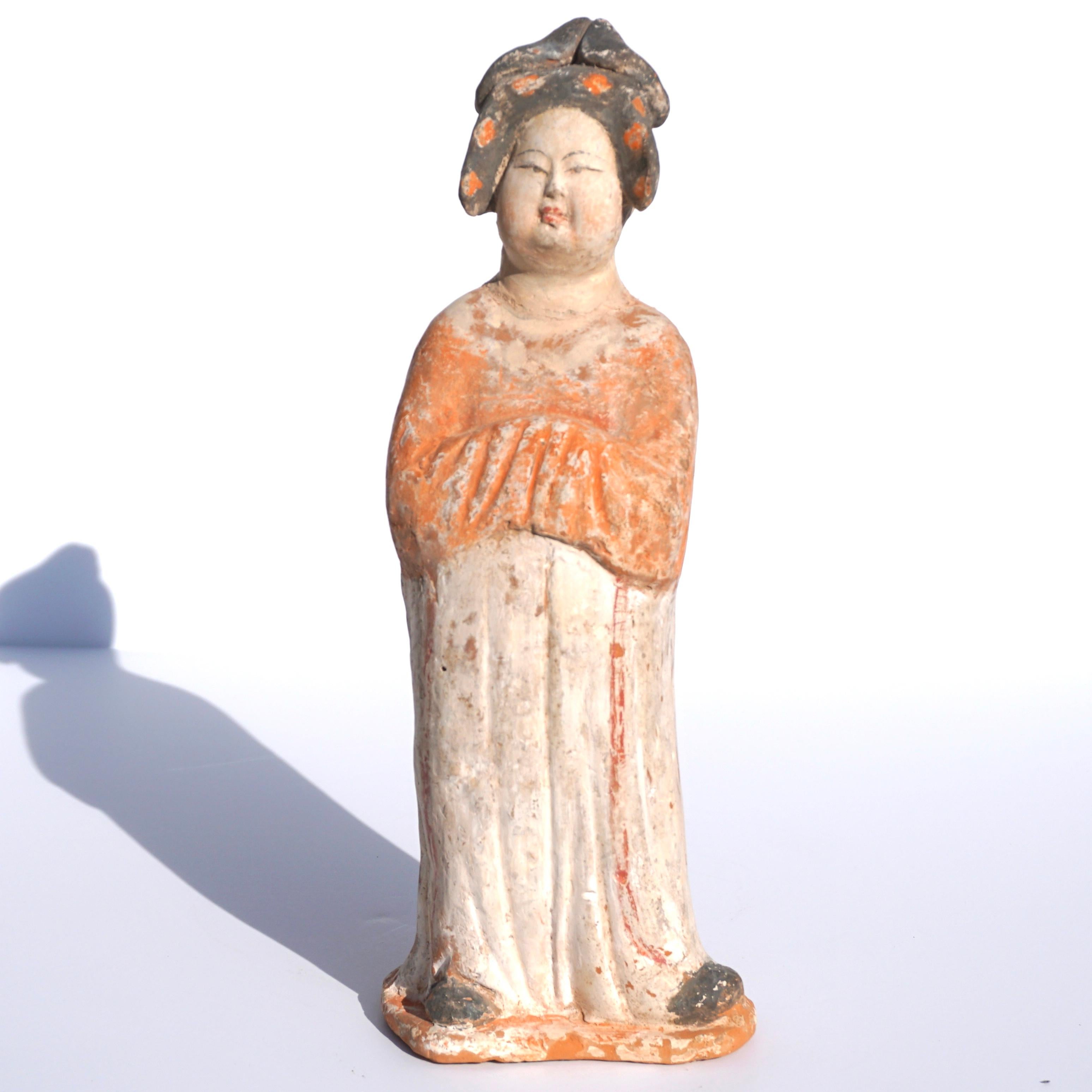 Tang Dynasty Terracotta sculpture of a fat lady

This stunning lady wears her hair in an elaborately styled coiffure. A remarkable amount of the original pigment that once decorated this work remains intact. Such women may represent wives,