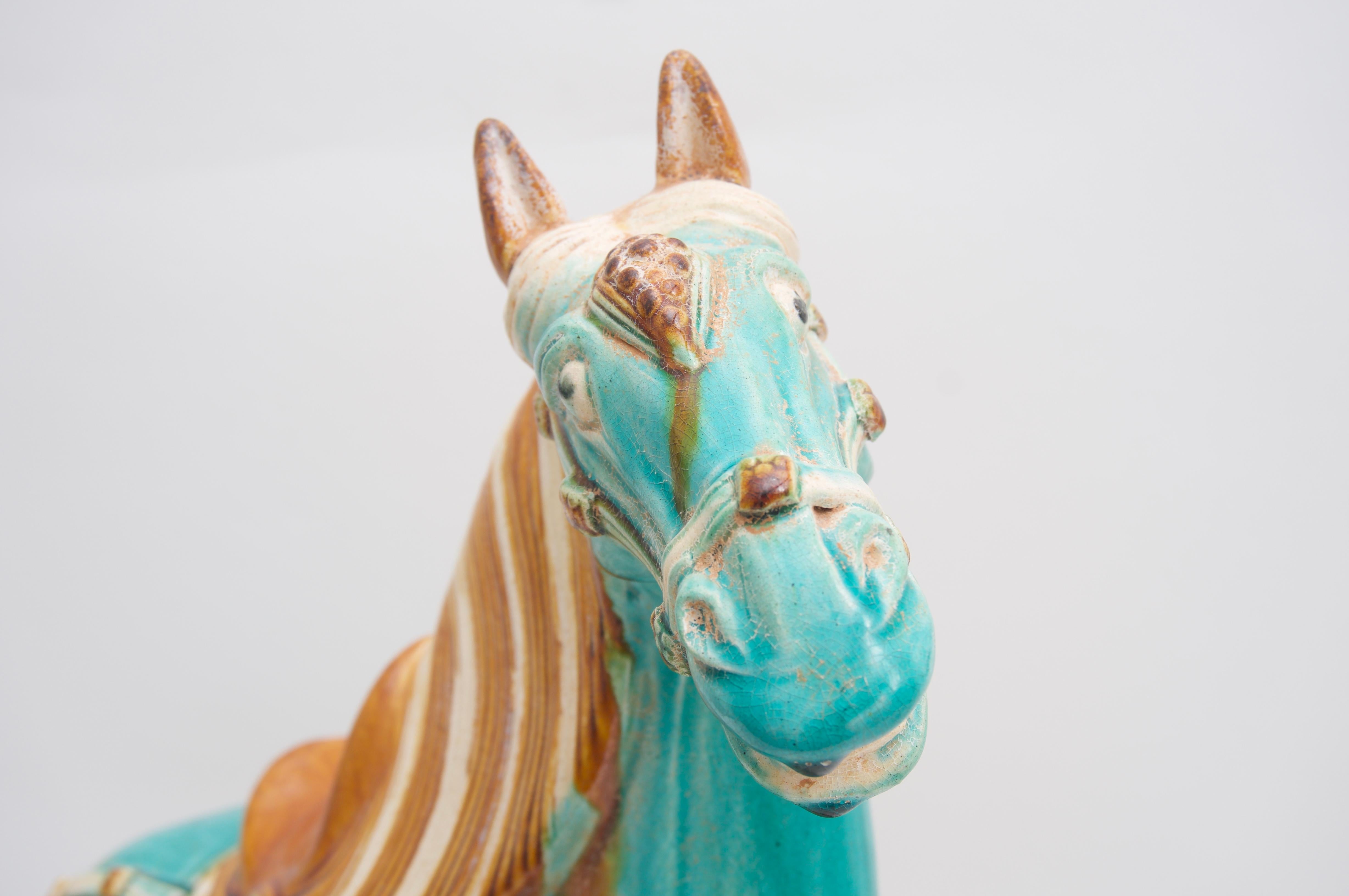This stylish and chic Tang dynasty style figure of a horse was acquired from a Palm Beach estate and it dates to the 1970s with its Classic Palm Beach turquoise glaze.