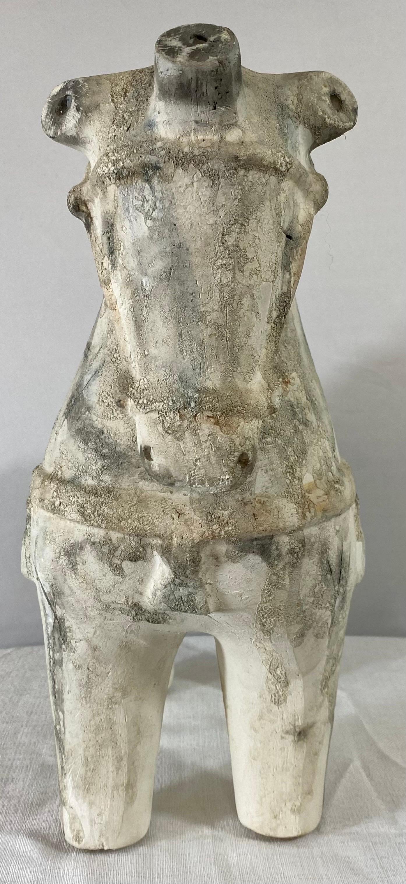 A charming Tang style pottery horse sculpture. The subculture is well crafted and shows beautiful patterns and design on the surface with gray coloration on the off white color as well as a hanging saddle.  

Dimensions: 16” H x 16” W x 8” D