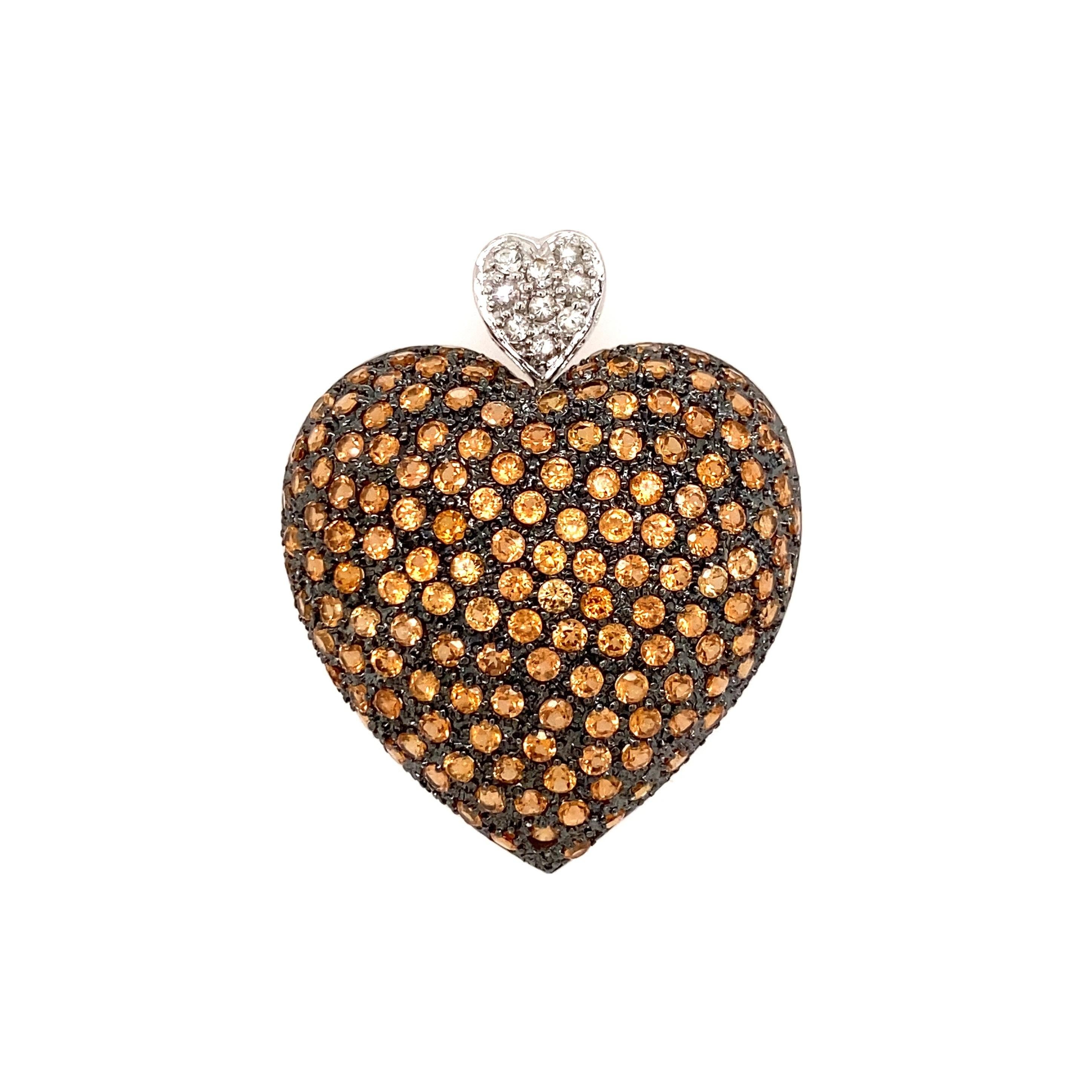 Simply Beautiful! Tangerine Garnet Pave Heart Gold Pendant. Hand set with round Tangerine Garnets, approx. 5.55tcw and accented with White Sapphires, approx. 0.21tcw. Hand crafted 14K White Gold and Black Rhodium mounting. Measuring approx. 1.65” l