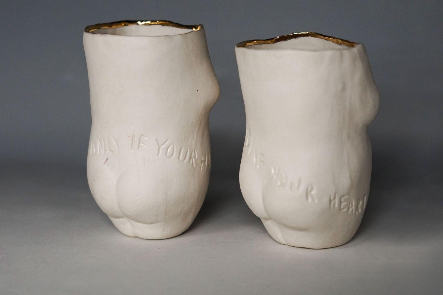 Hand-Carved Tangible Morality, Pair of carved porcelain cups with gold rim 