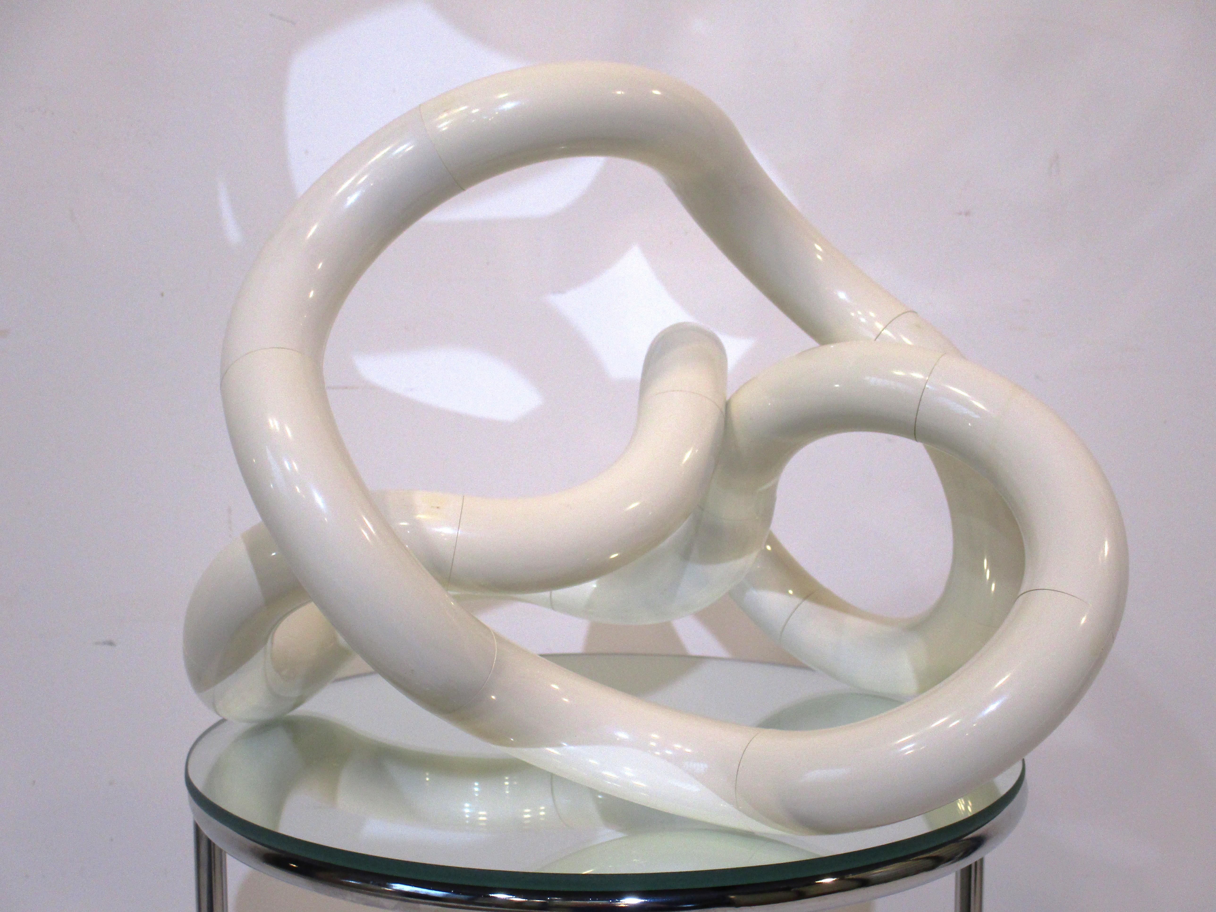 A off white poly resin articulating sculpture called the Tangle because it can be turned and twisted into many shapes looking tangled up . This well thought out piece was designed by Richard X Zawitz in 1980 and manufactured by Tangle Creations