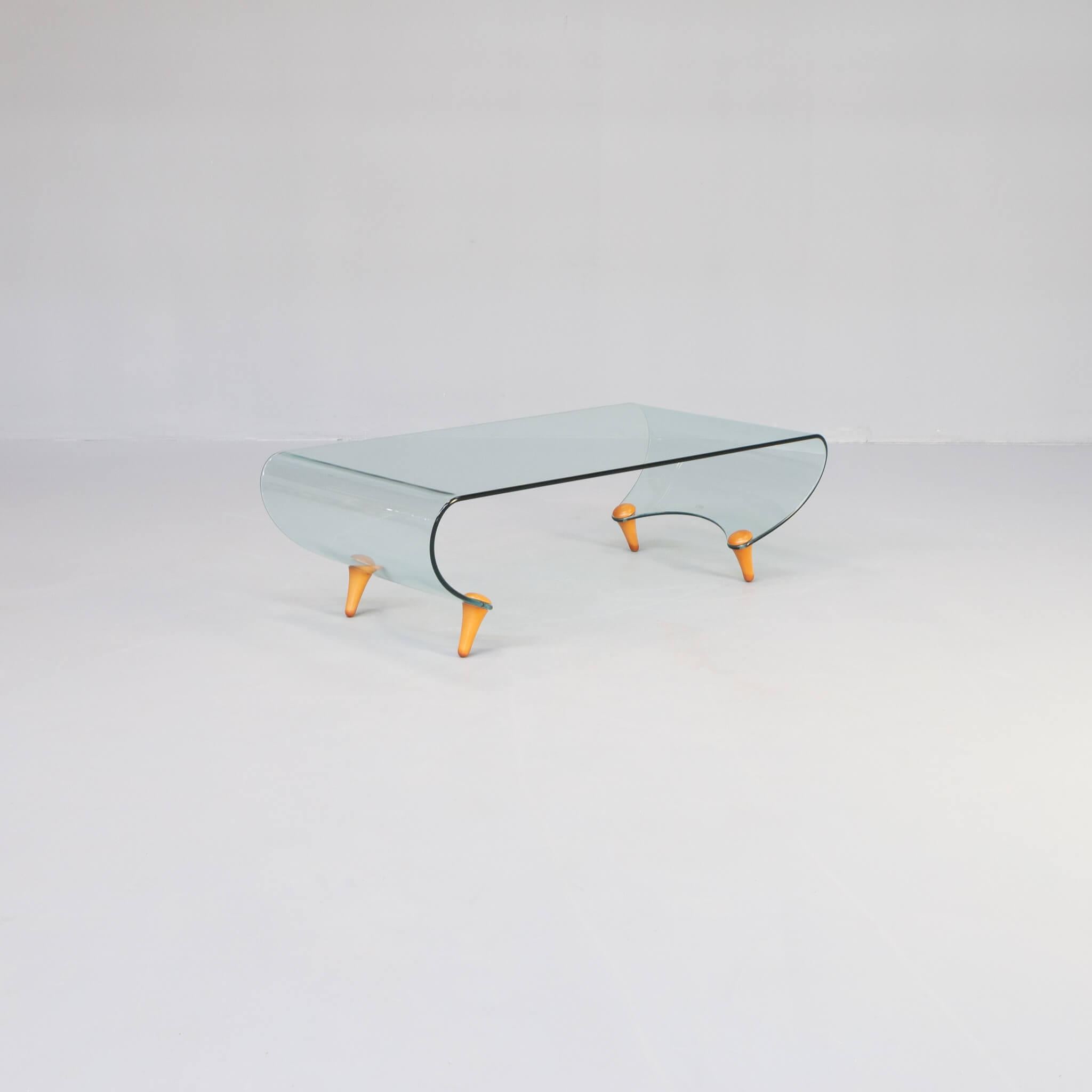 This lovely and rare coffee table was designed in 1996 by Fabio di Bartolomei for Fiam Italy. 

The table is made of very solid curved glass and four wooden legs.
It is no longer in production. 

Signed in the glass: FIAM Italian AB-II. 

Very good