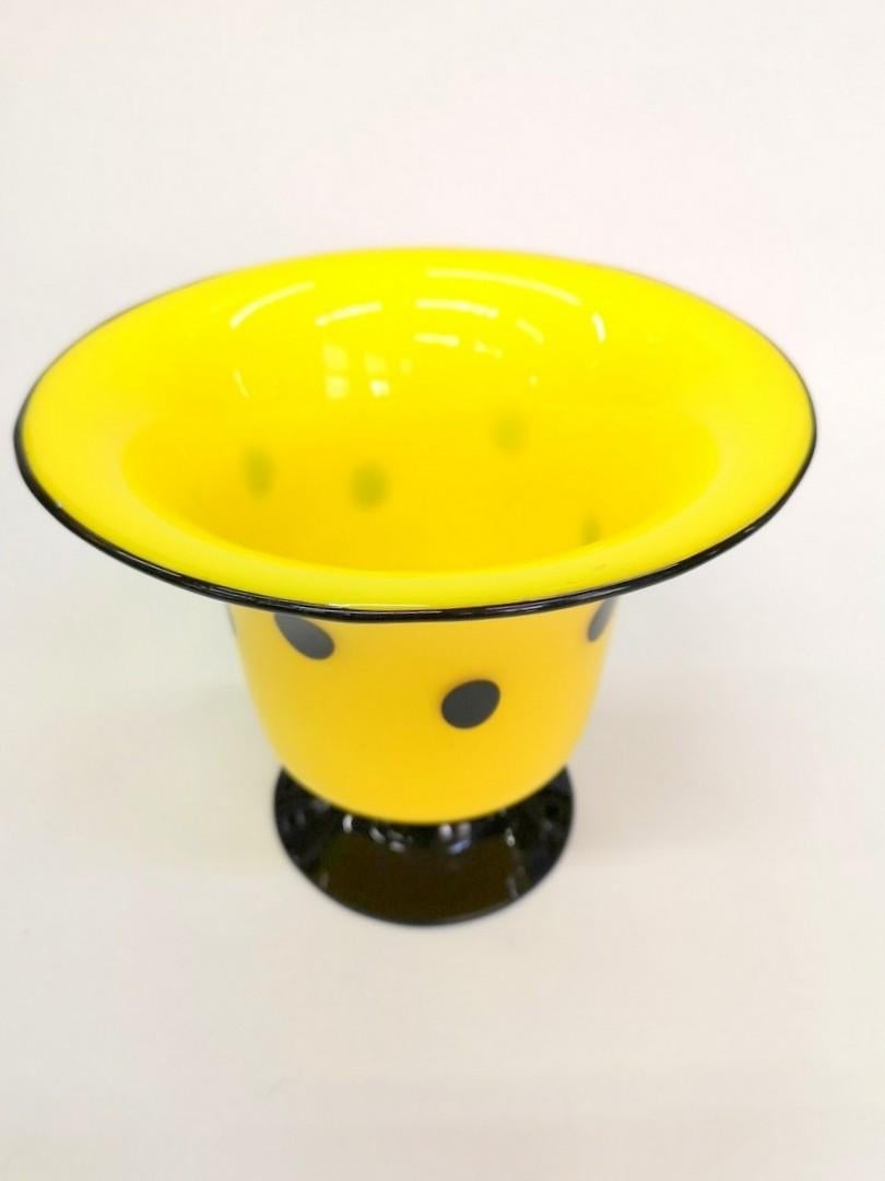Opaque yellow glass trimmed with black sides and spots, this Tango vase was made by Loetz and designed by Michail Powolny, in the 1920s.
