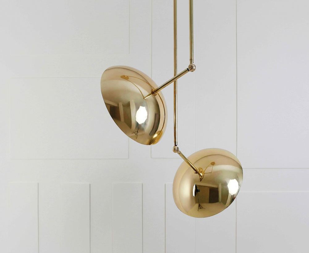 Tango is born from playful experimentation with vintage lighting components to create lighting fixtures that fuse sculptural form with hand-worn materials. Articulating elbows and brass shades create a sophisticated armature that emits soft pools of
